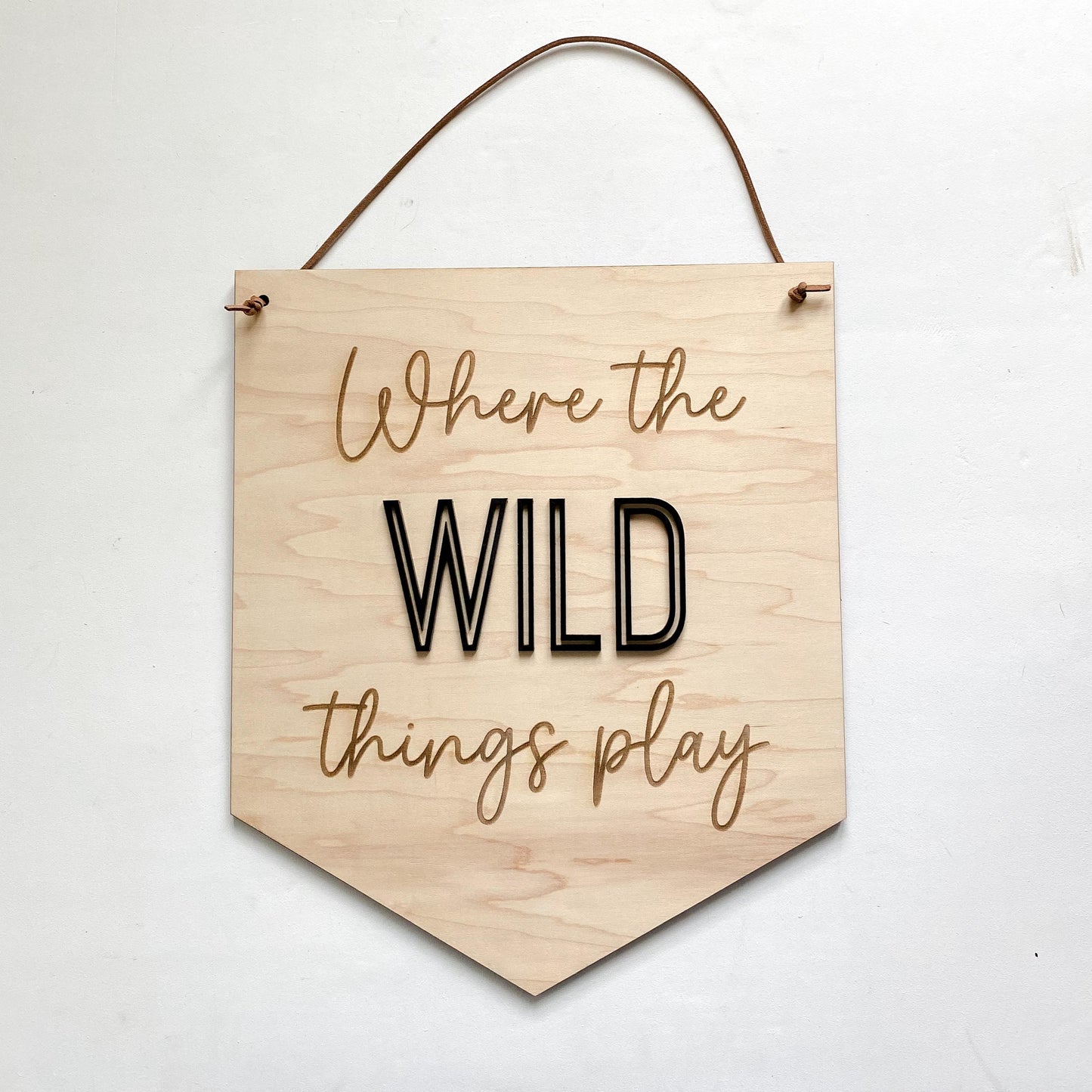 Where the Wild Things Play wooden playroom sign showing engraved lettering detail