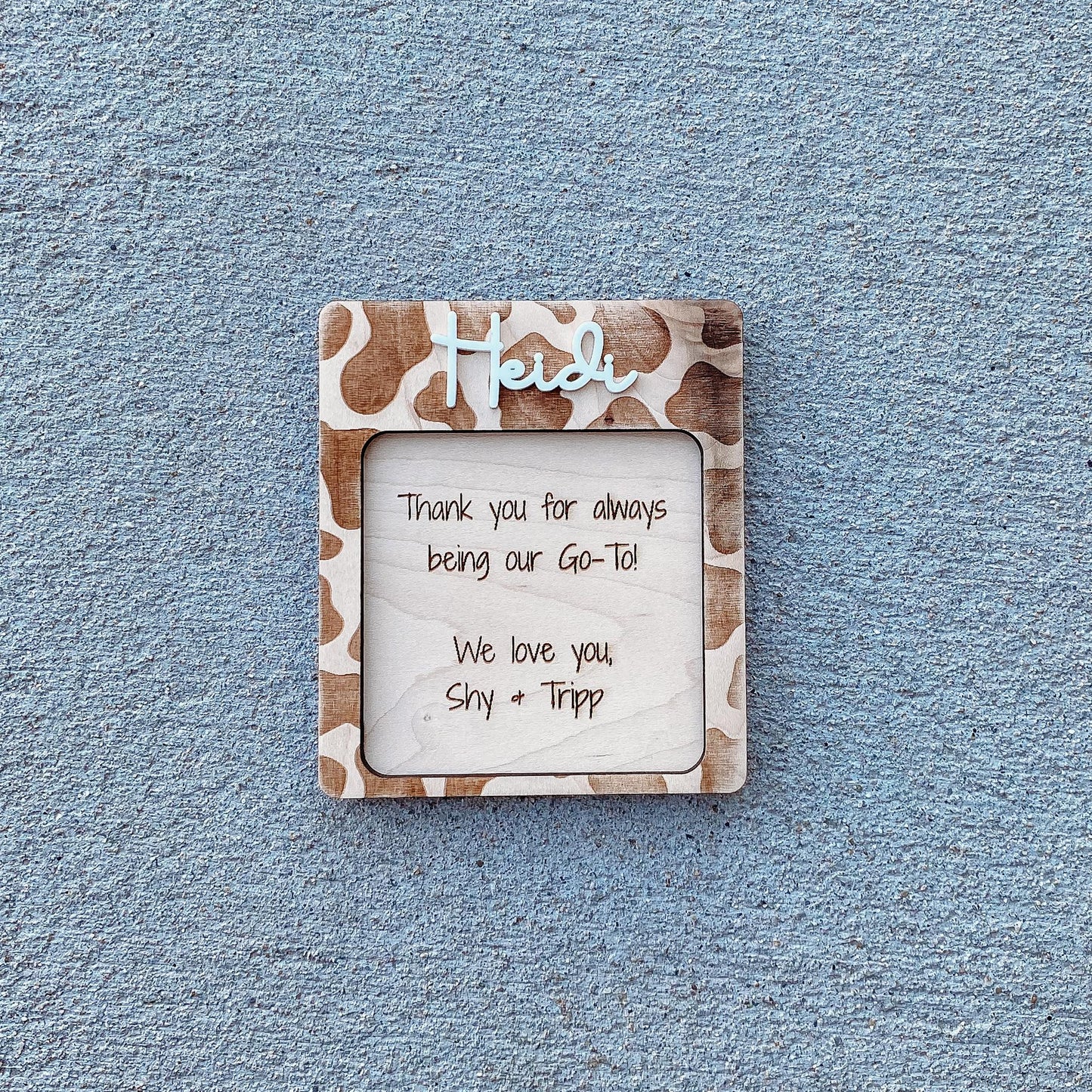 Personalized cow print note pad holder showing black and white cow pattern on wood