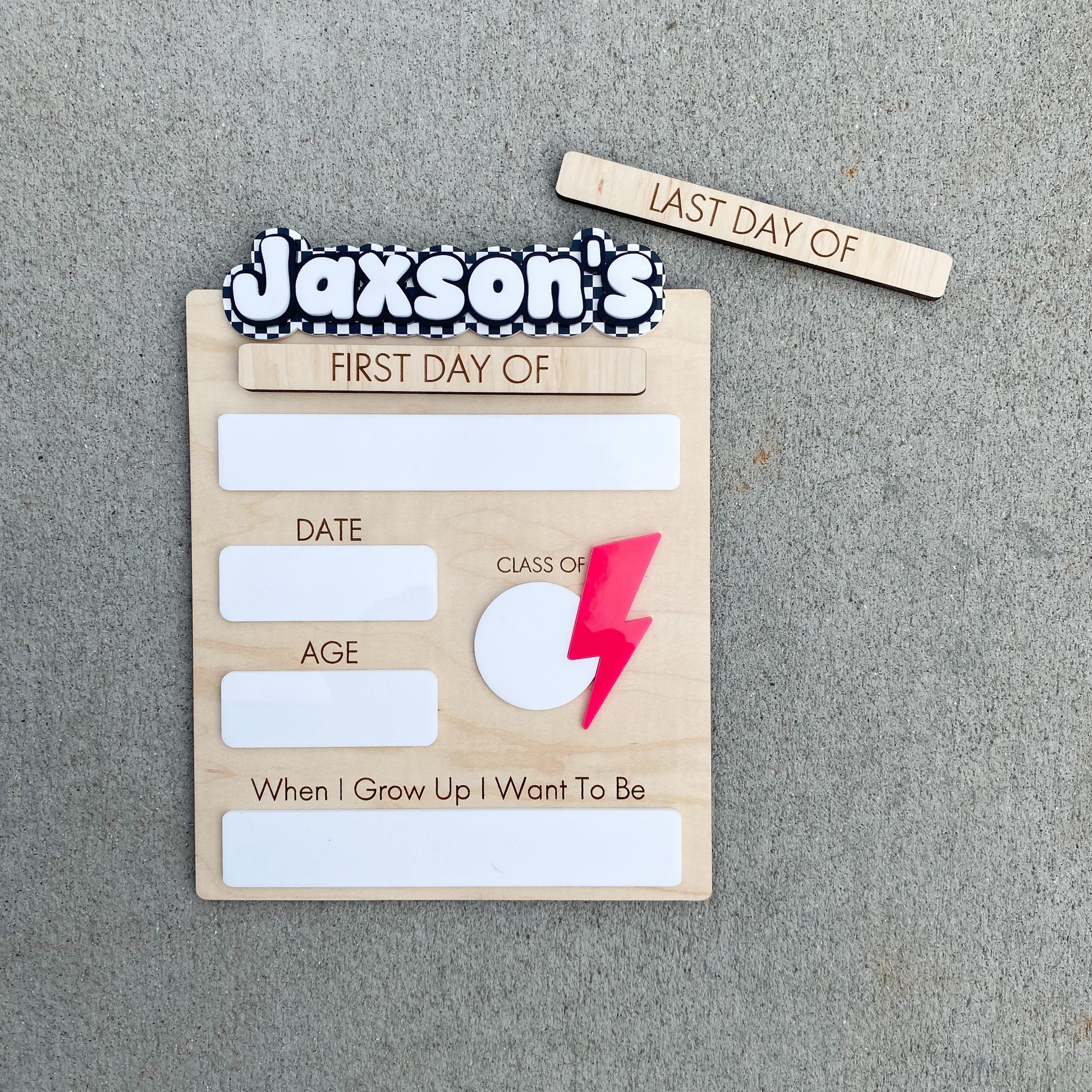 Close-up of checkerboard first day of school sign with personalized name detail