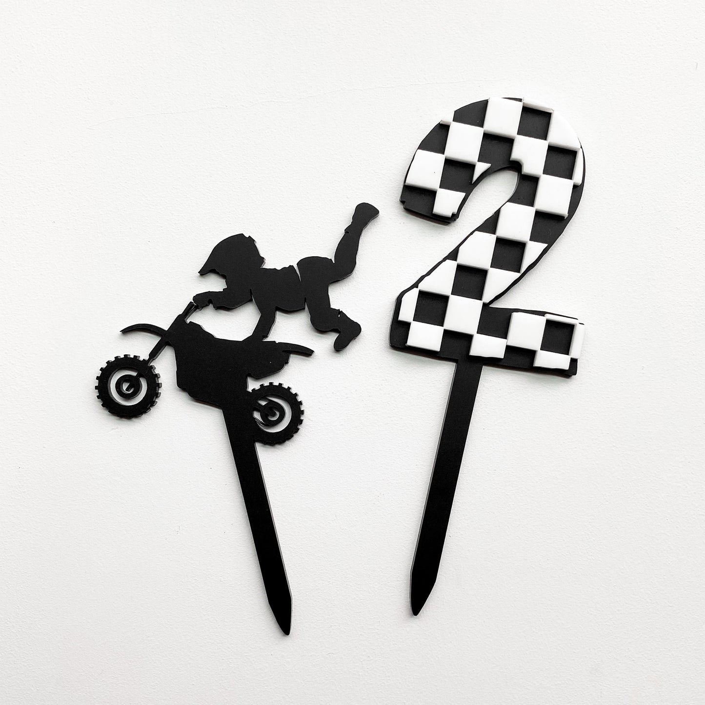 Dirt bike motocross cake topper displayed on birthday cake, bold party decoration