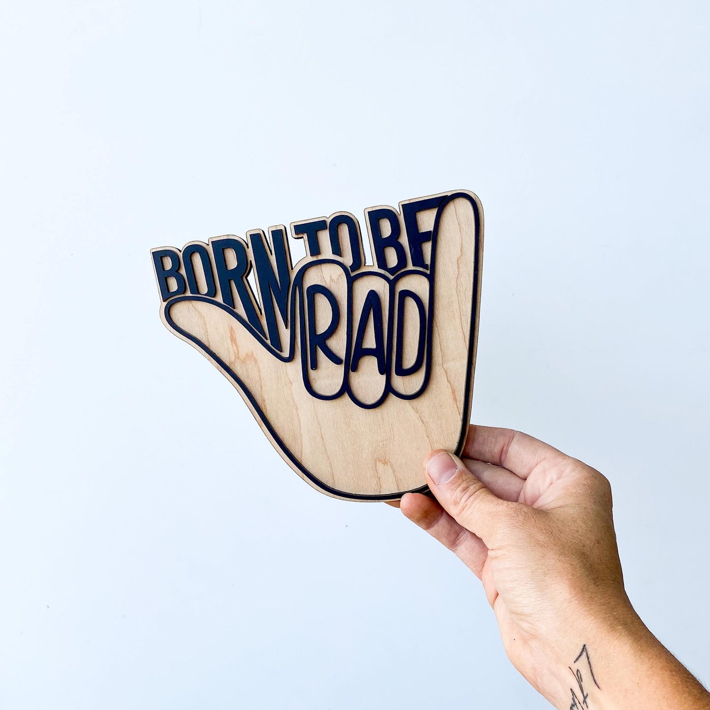 Born To Be Rad wall sign styled in nursery with neutral boho decor