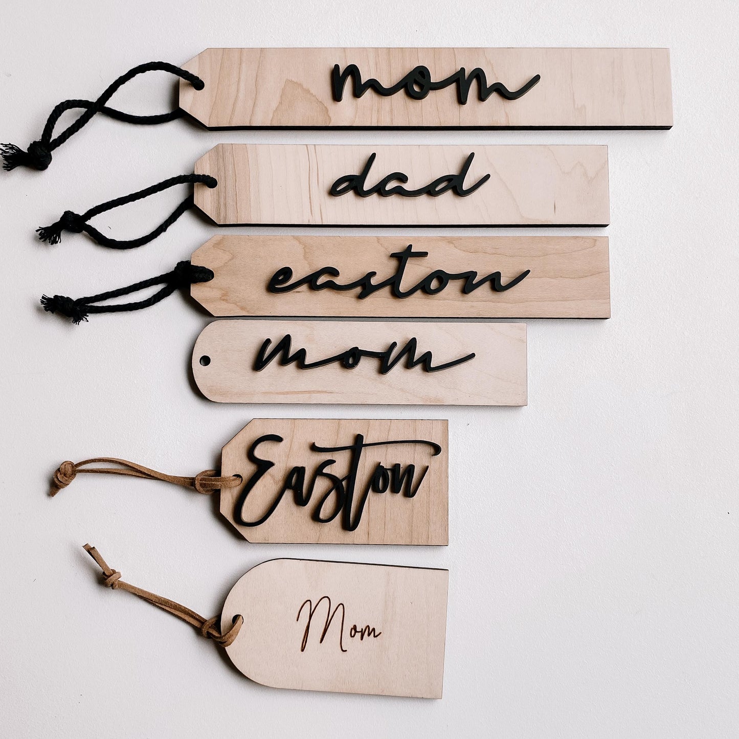Close-up of boho wood Christmas stocking tag with personalized name engraving