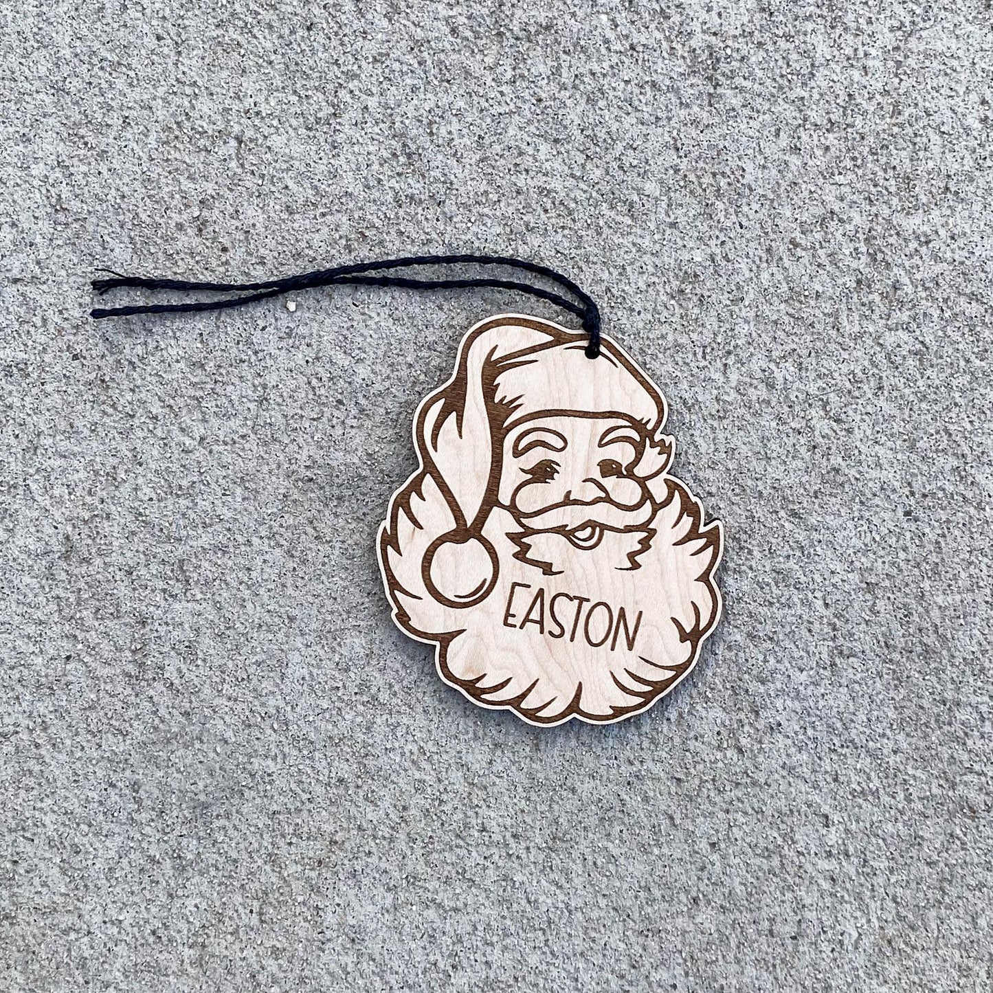 Santa stocking tag in maple wood showing engraved name for Christmas stocking display