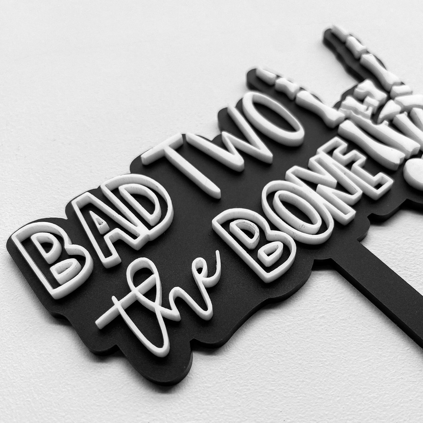 Bad Two the Bone birthday cake topper displayed on smash cake, custom 2nd birthday decor