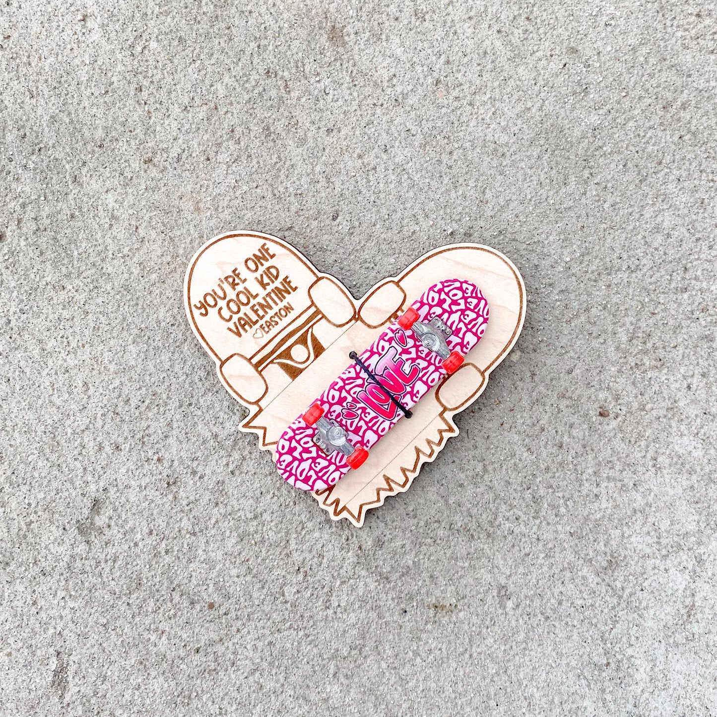 Close-up of mini skateboard Valentine card with tiny skateboard attachment