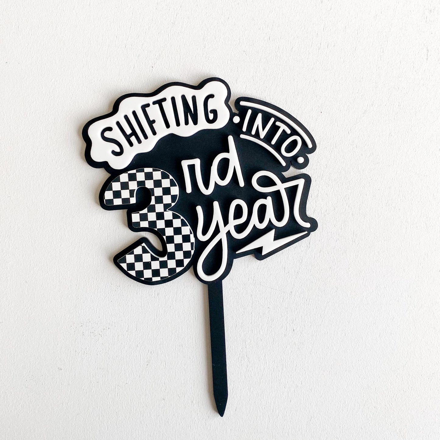 Personalized Shifting into Gear racing cake topper showing checkered number design