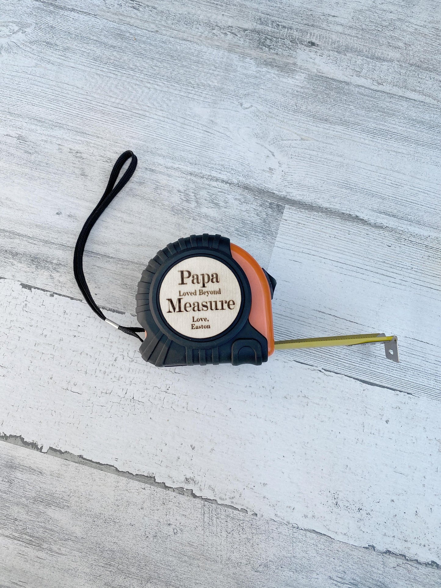 Personalized wooden tape measure displayed as Father's Day gift for handy Dad or Grandpa