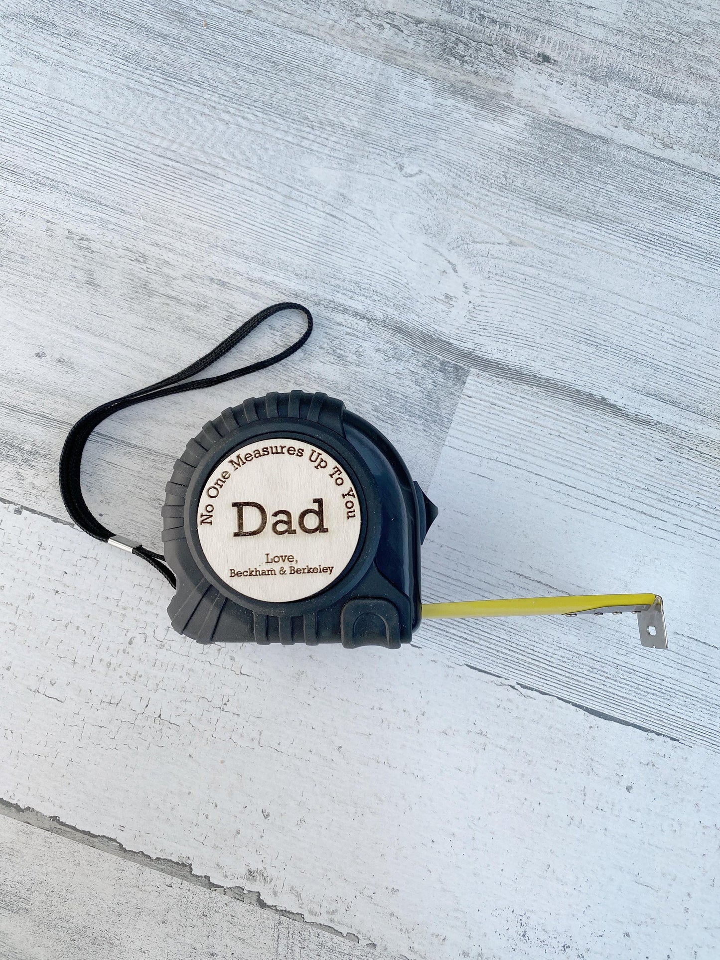 Custom engraved tape measure for Dad showing personalized message and name