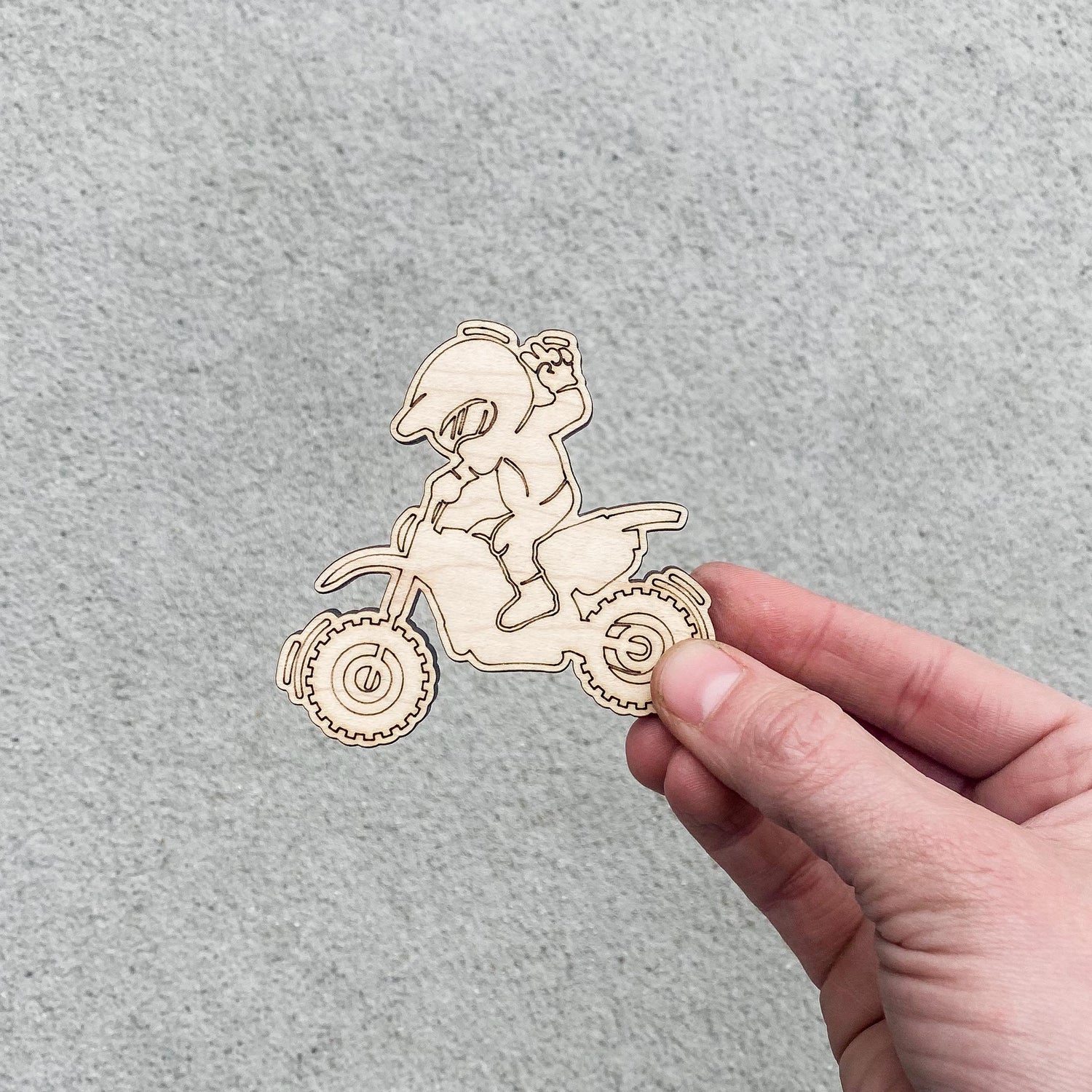 Colored-by-you dirt bike favor with marker next to topper, ready for assembly or gifting