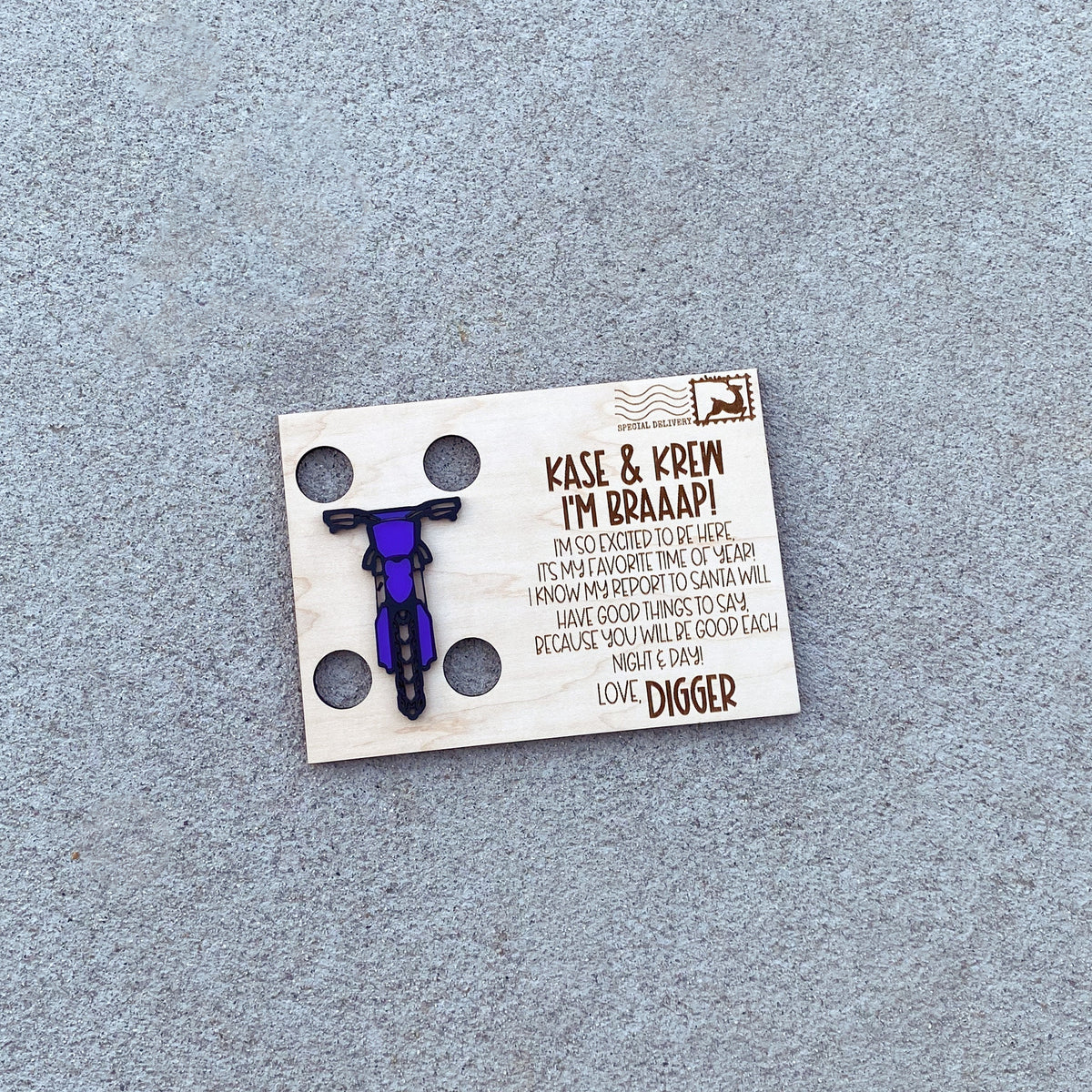Personalized one elf dirt bike postcard with a purple bike, children's names and elf signature engraved in wood