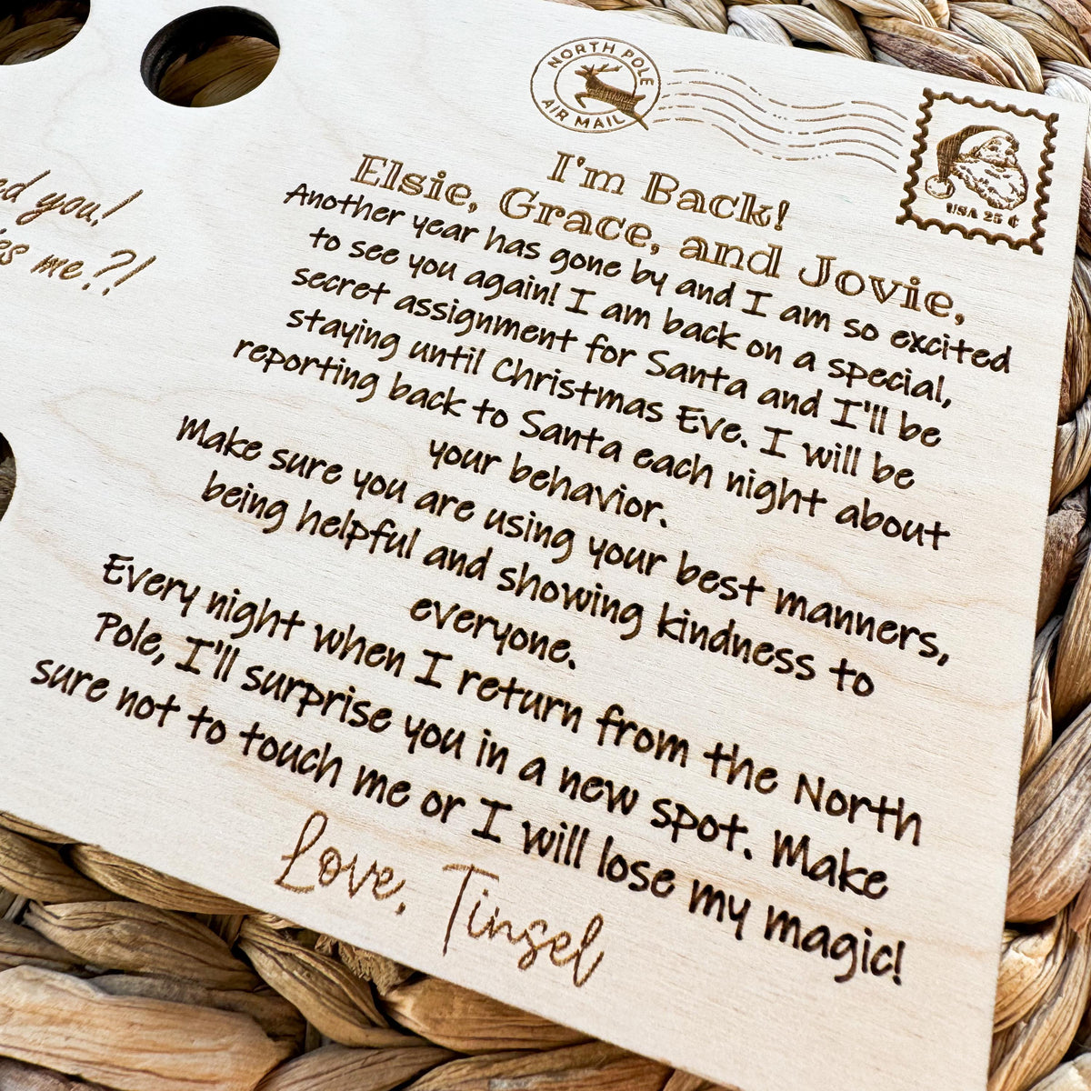 Angled close-up of the engraved elf welcome back letter showing the personalized message and elf signature