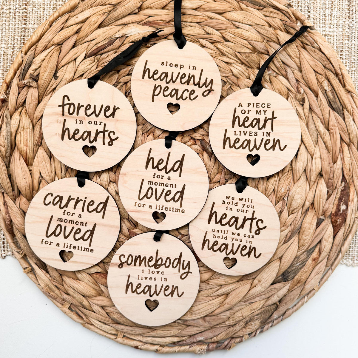 Wooden memory ornament engraved with a name and date to honor a baby