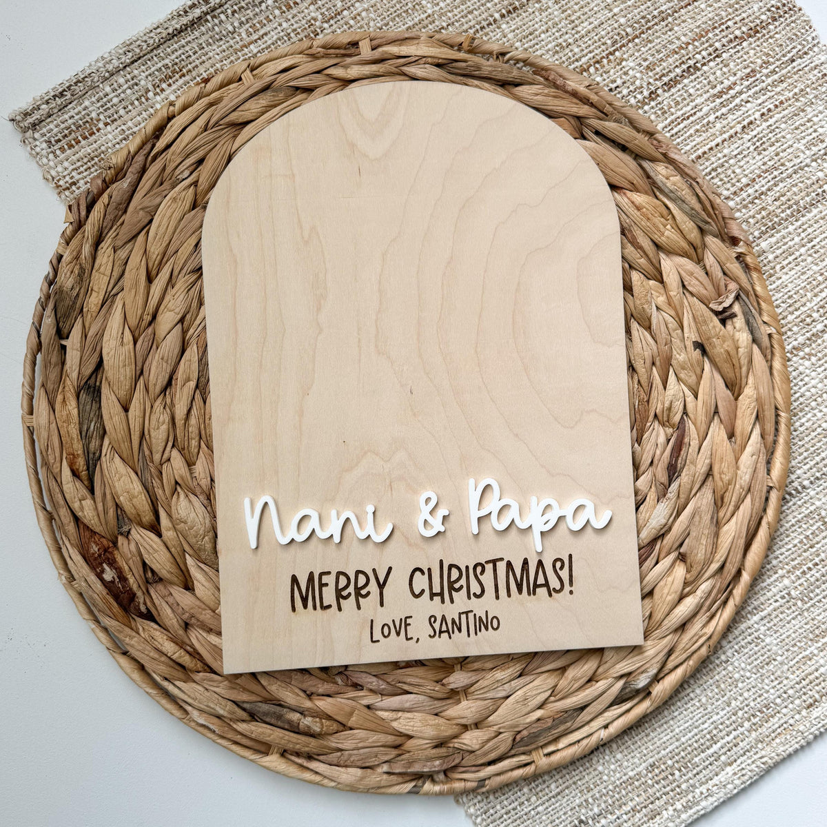 Blank maple wood keepsake sign personalized for grandparents with white acrylic names and an engraved Merry Christmas message, ready for grandkids to add their handprints