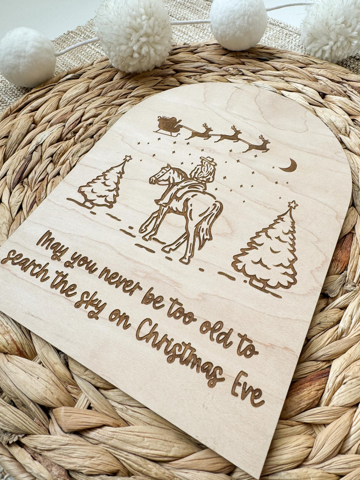 Engraved sign reading May you never be too old to search the skies on Christmas Eve