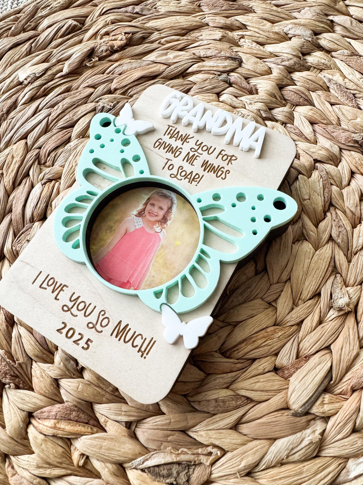 Close-up of the acrylic butterfly accent on a wood photo frame