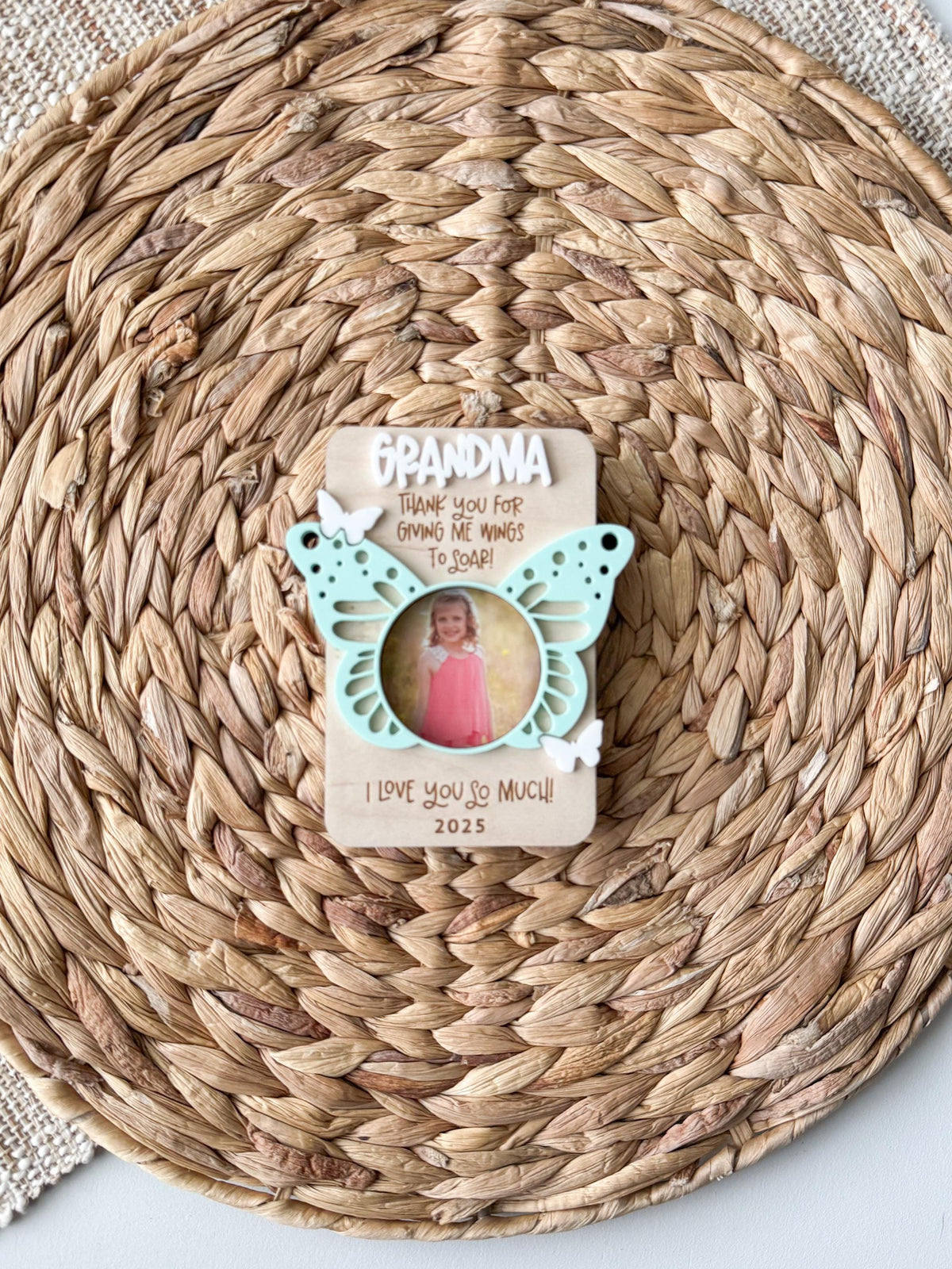 Personalized butterfly photo magnet holding a small photo, about 3.5 x 4.5 inches