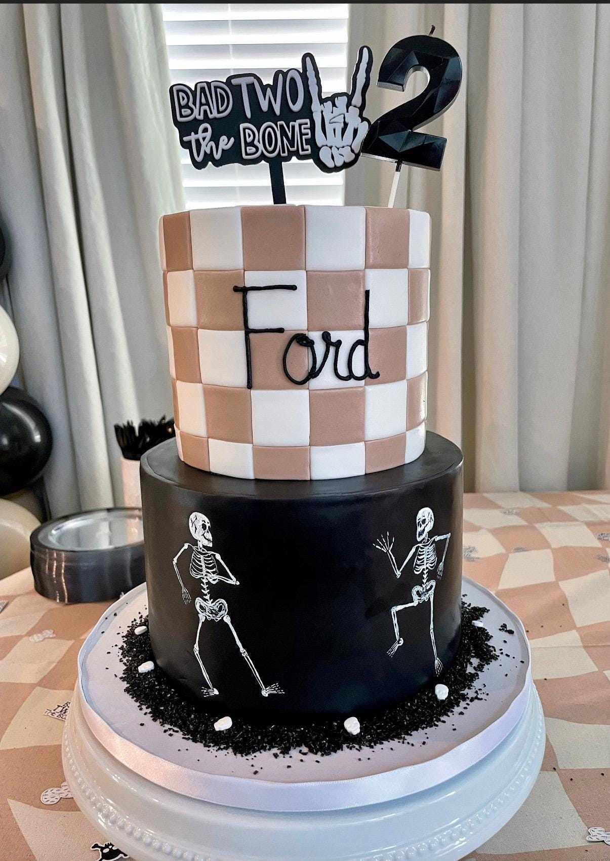 Personalized Bad Two the Bone skull birthday topper showing acrylic construction