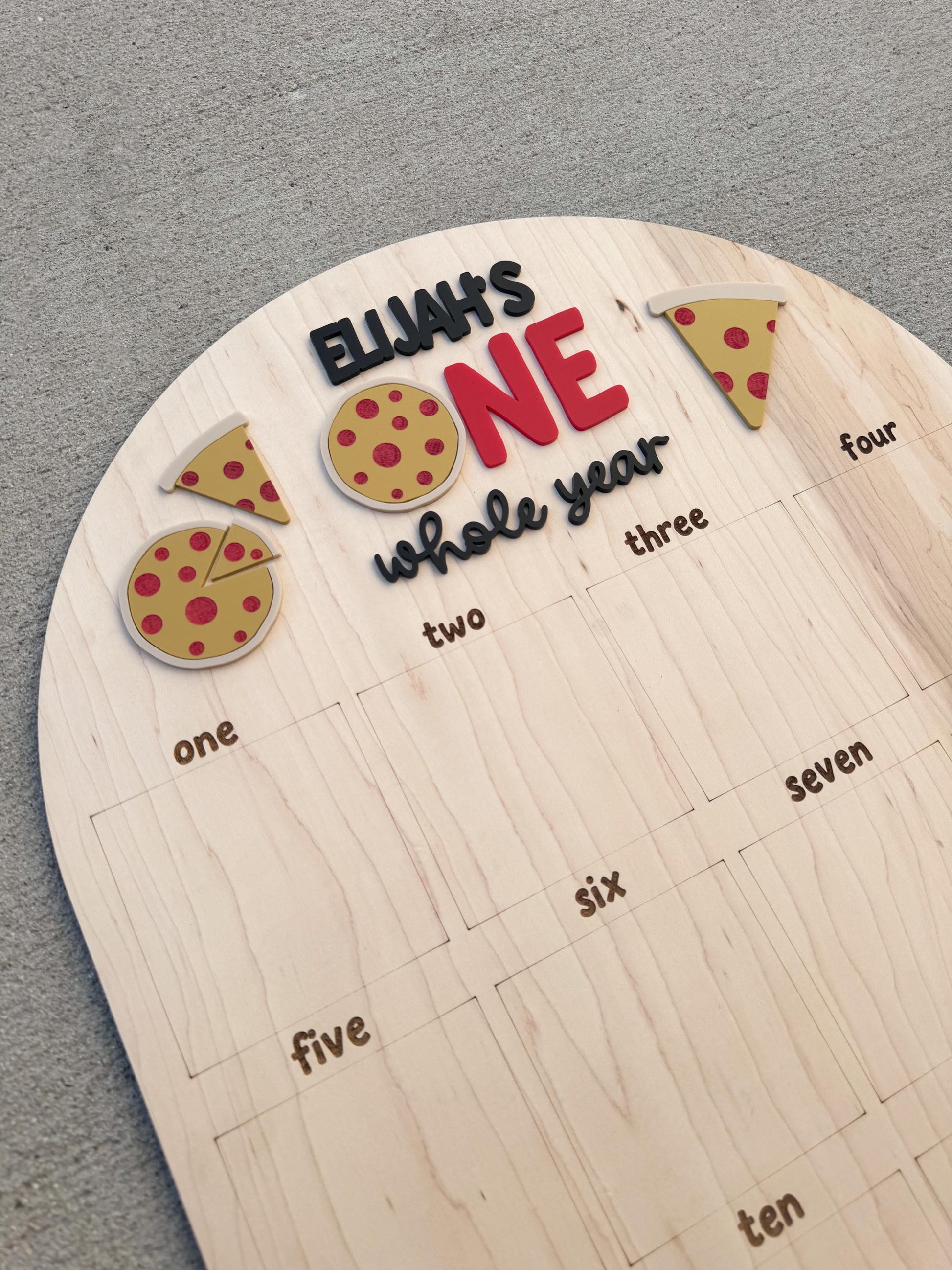 Pizza first birthday photo board showing 12 monthly photo slots and personalized name