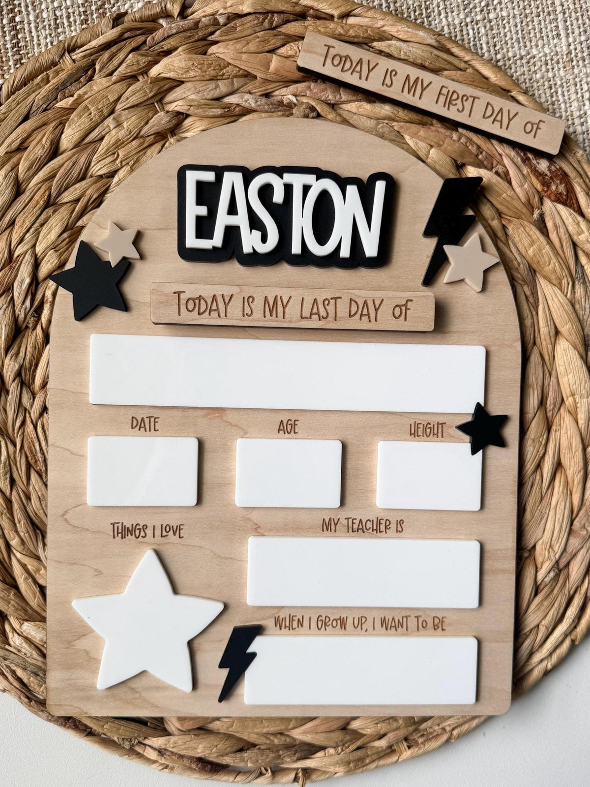 Personalized first day of school sign - round maple wood board engraved "EASTON, Today Is My First & Last Day Of" with reusable dry-erase fill-in boxes (date, age, height, teacher, things I love), black & white stars and a lightning bolt. Interchangeable back-to-school photo prop.