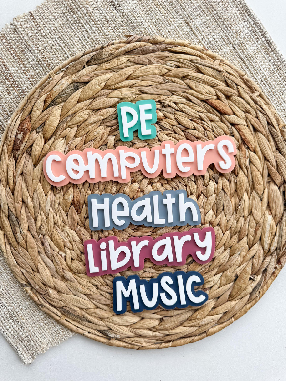 Close-up of personalized classroom subject magnets with magnetic backs, ideal for organizing daily school schedules