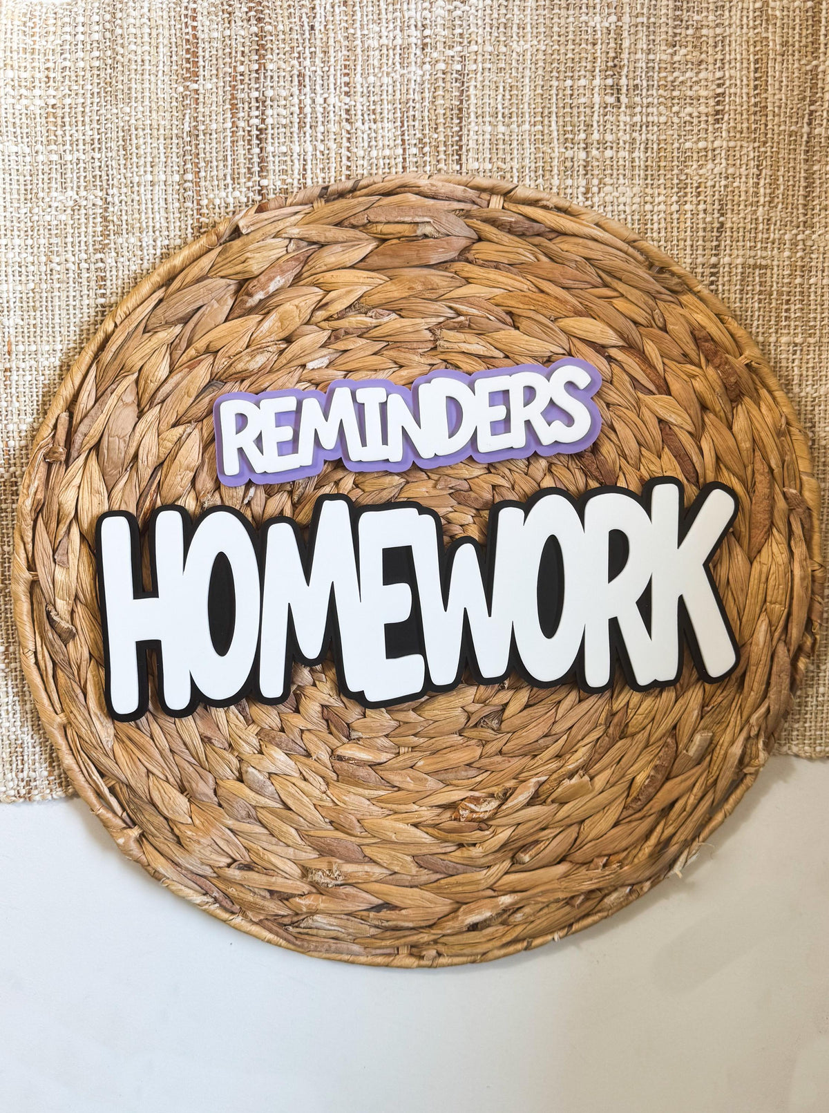 Layered acrylic Homework and Reminders magnets in white with black outline on purple backing