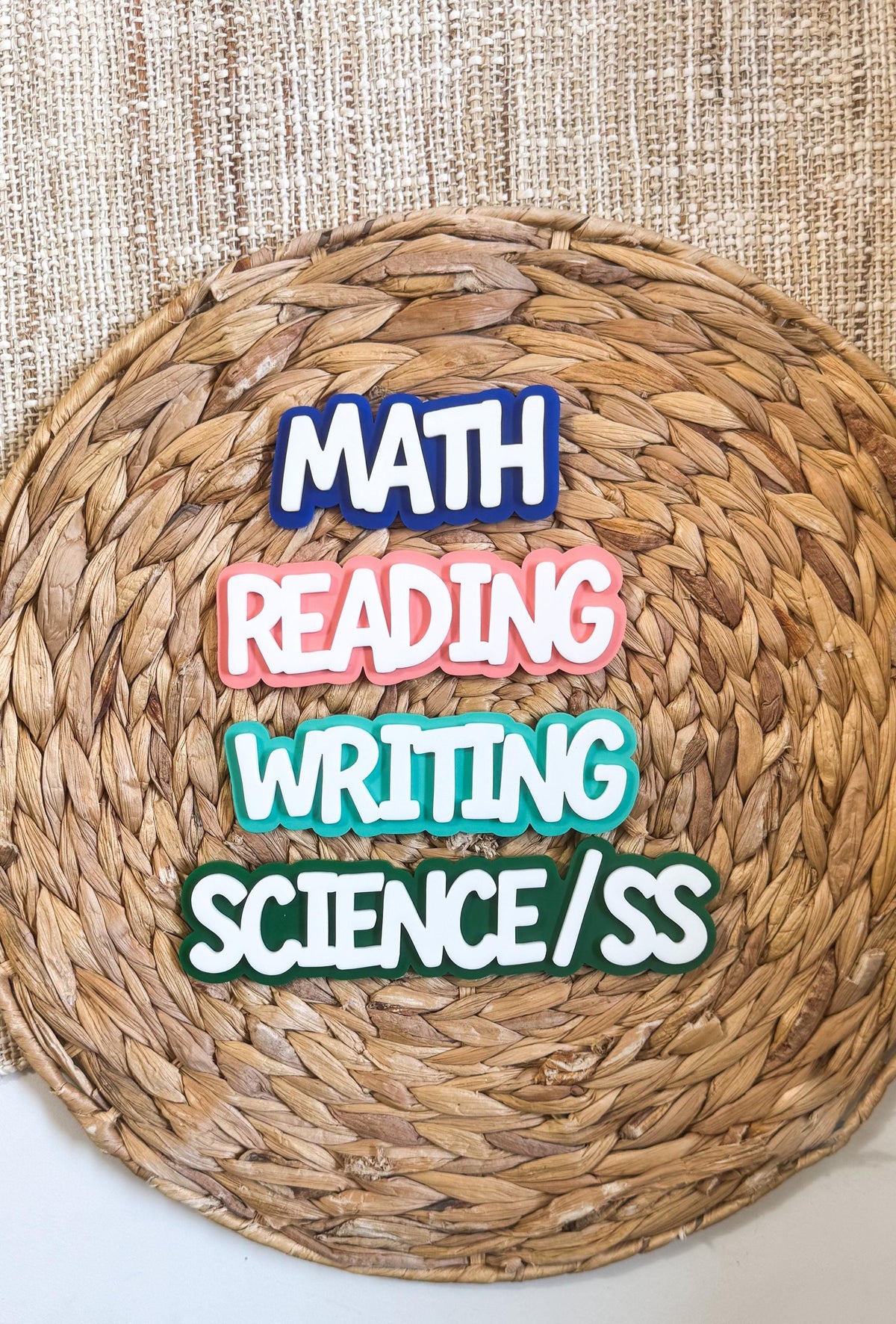 Layered acrylic classroom subject magnets for Math, Reading, Writing and Science/SS with white lettering