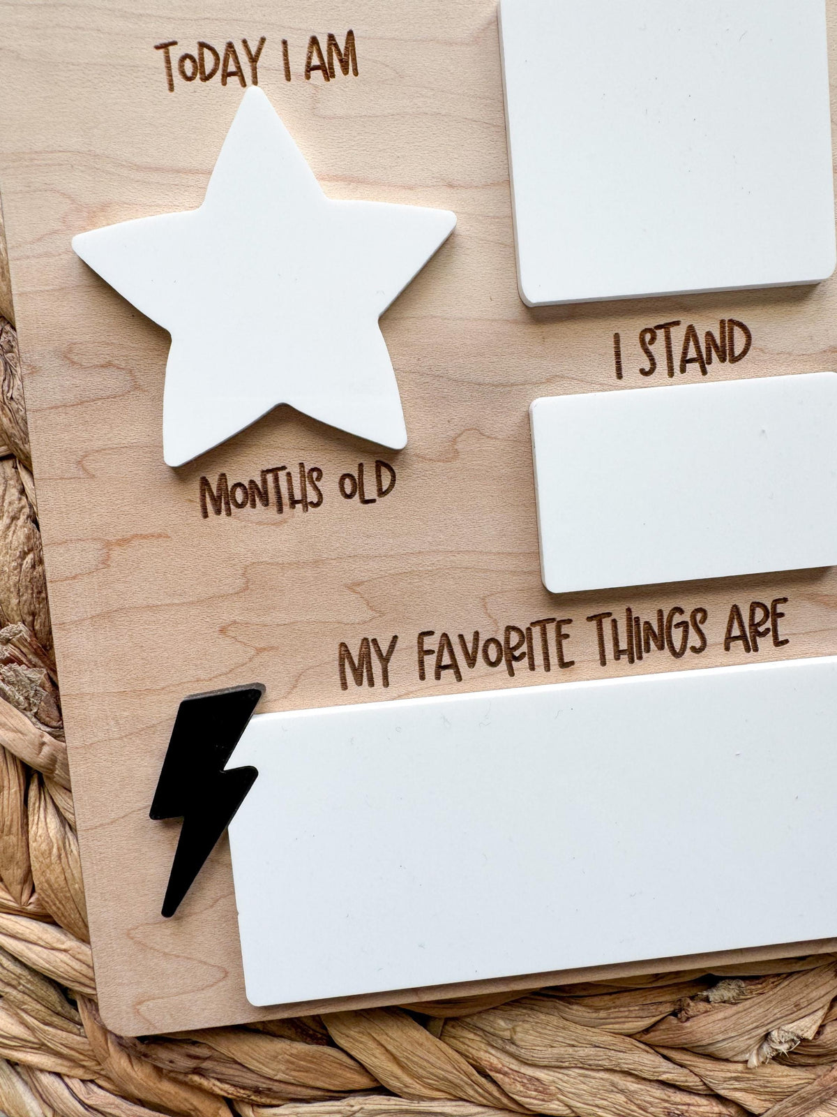 Close-up of the dry erase acrylic stats sections on a baby milestone sign