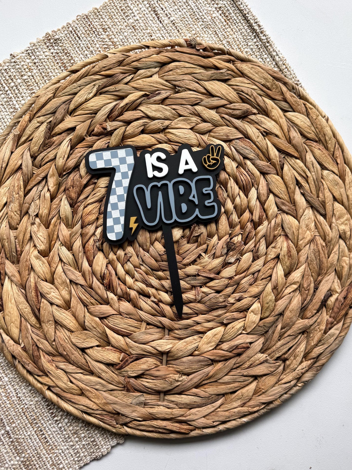 Is a Vibe retro checkerboard acrylic cake topper, personalized with custom age
