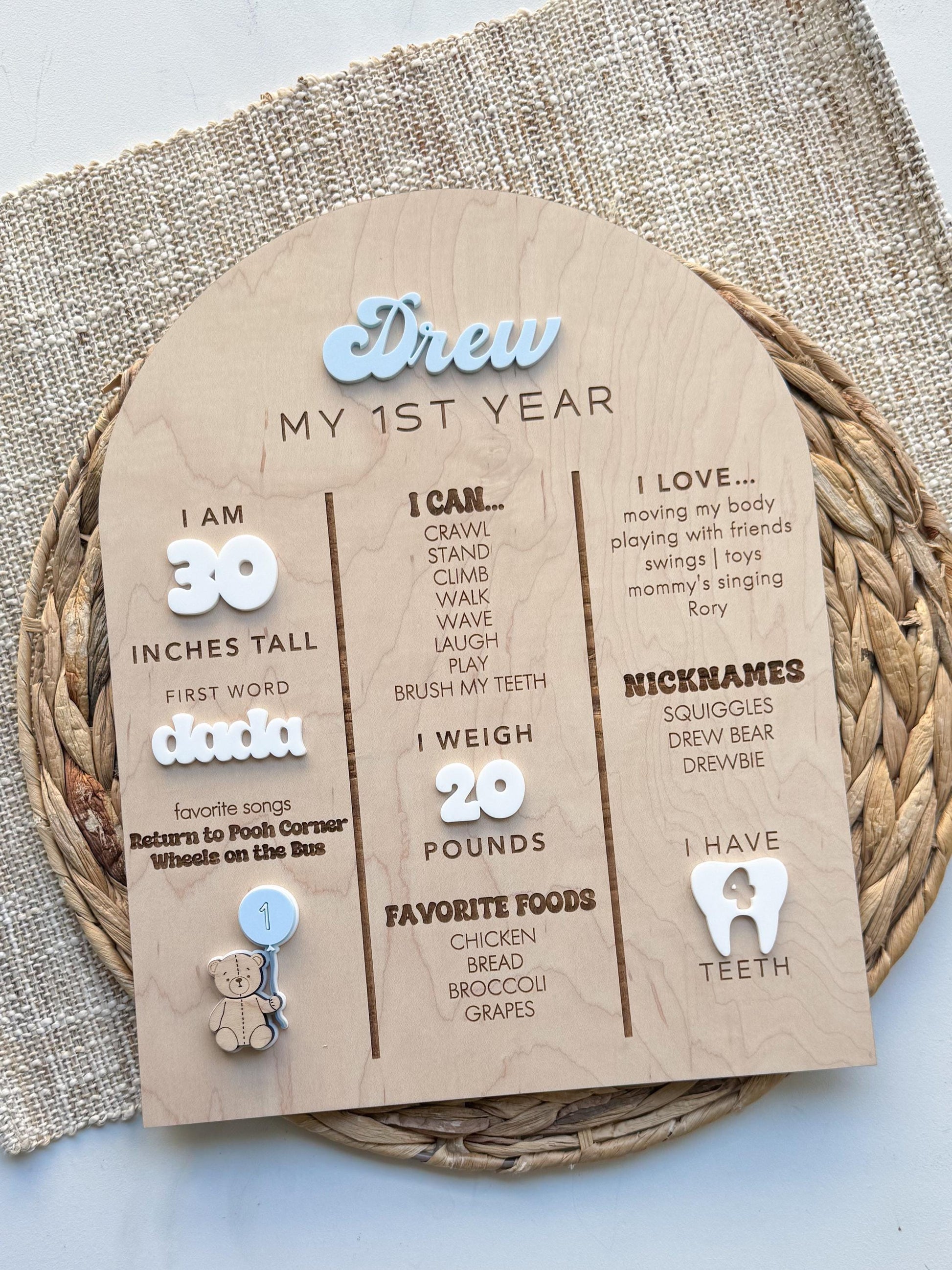 Teddy bear first birthday photo board showing 12 monthly photo slots and personalized name