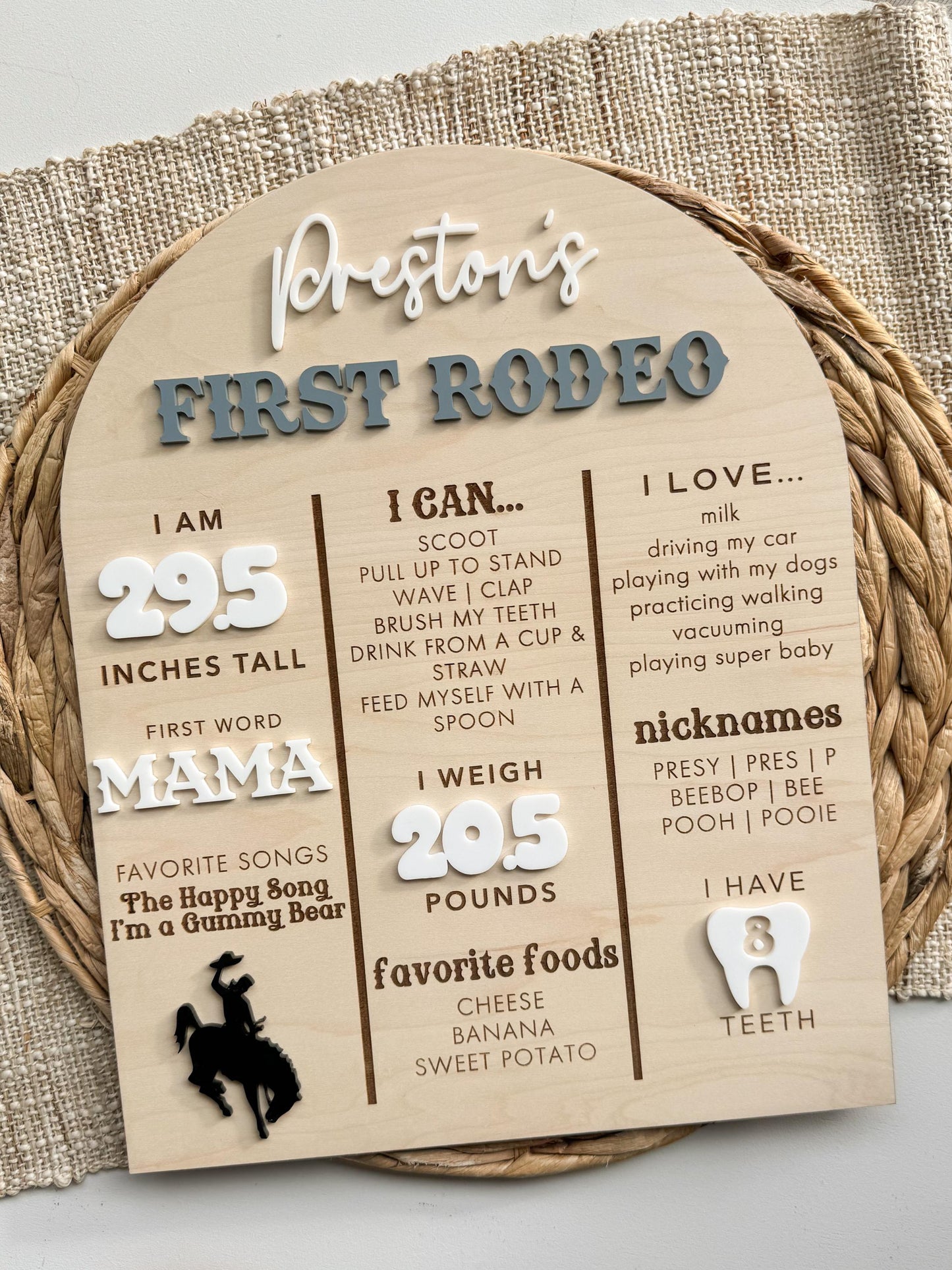 Close-up of First Rodeo milestone board with personalized name and western baby stats