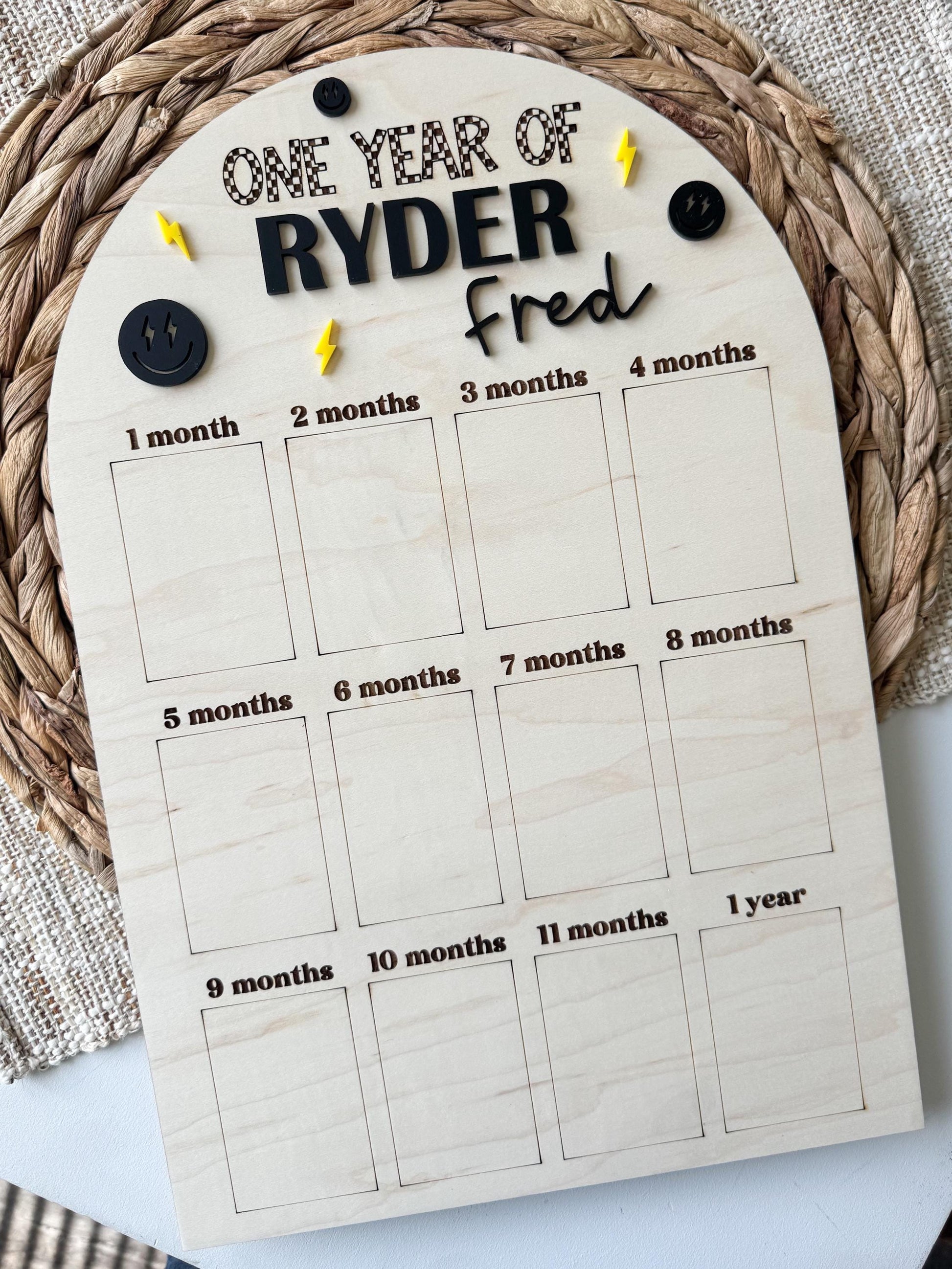 Custom first birthday 12-month photo display board showing monthly photo slots and name