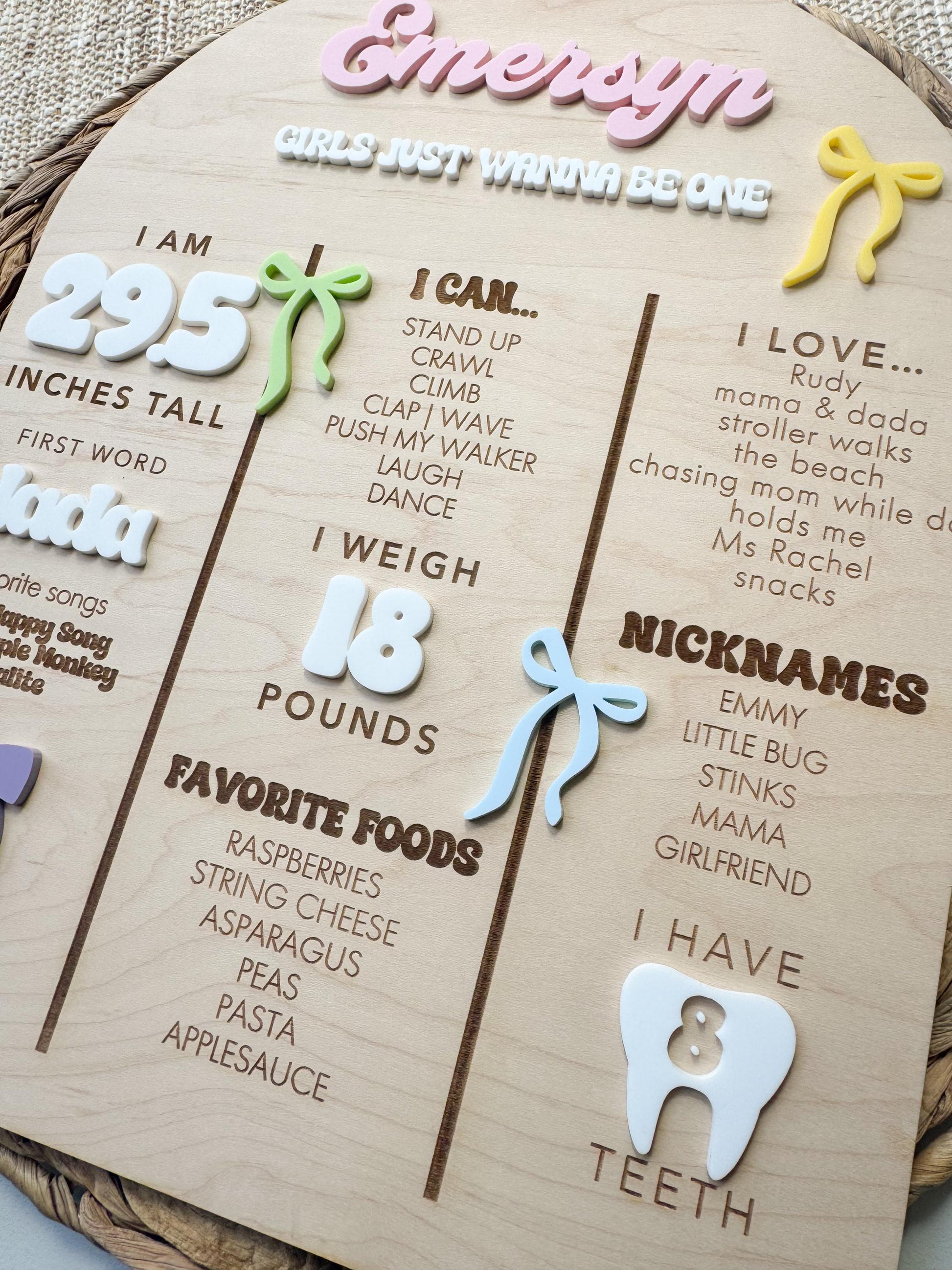 Personalized bow first birthday stat board showing baby name, height, weight, and milestones