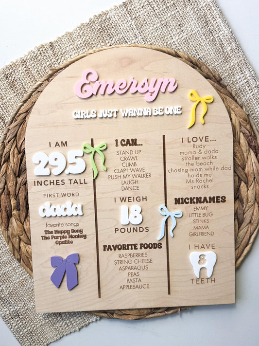 Bow theme first birthday milestone board in maple wood with personalized baby stats