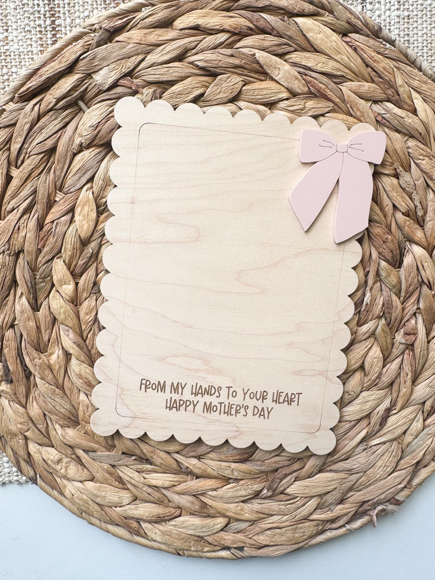 Handprint keepsake sign with bow design showing child's handprints and personalized name on wood