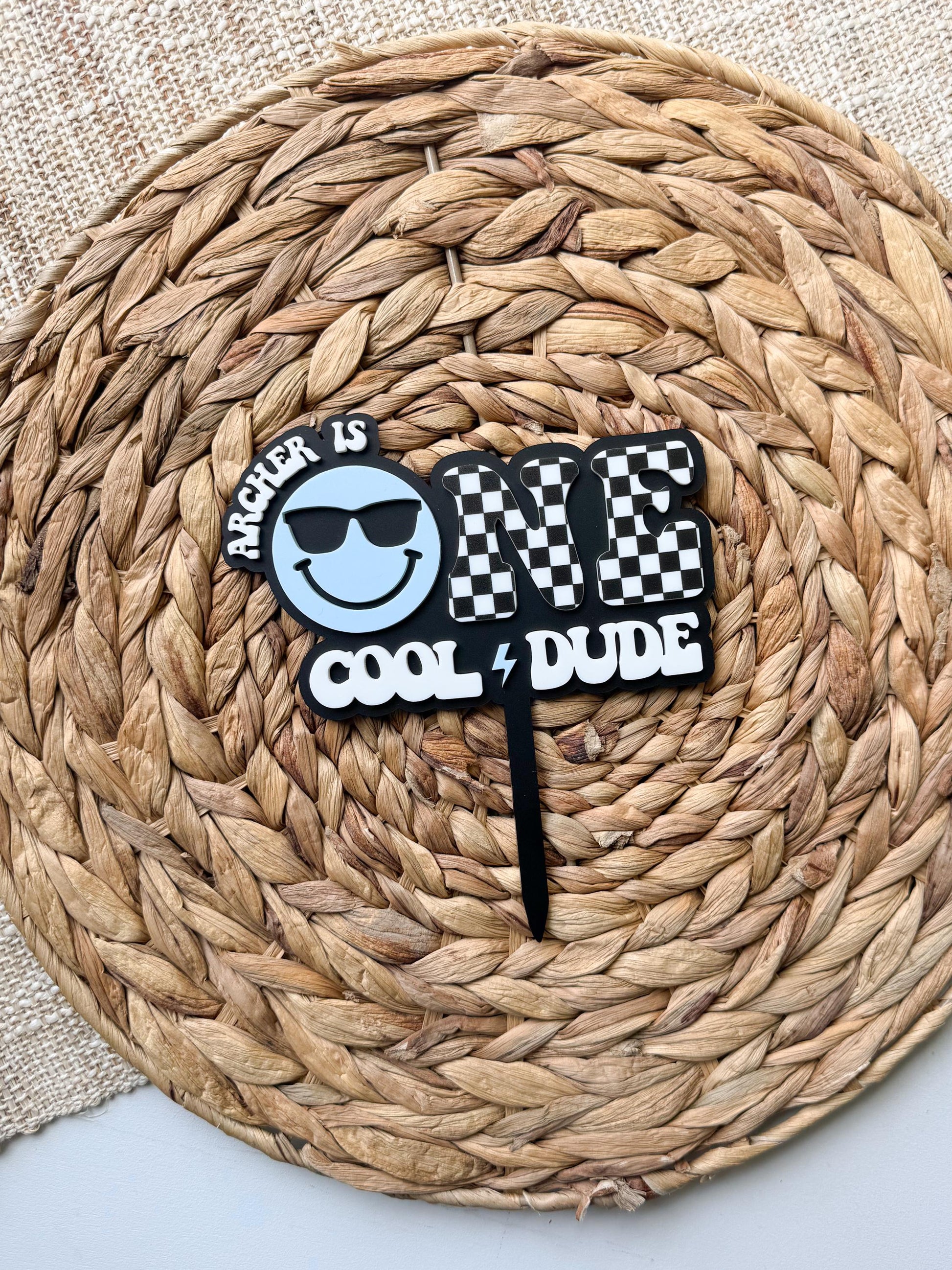 Cool dude cake topper displayed for smash cake photo with modern boy birthday theme