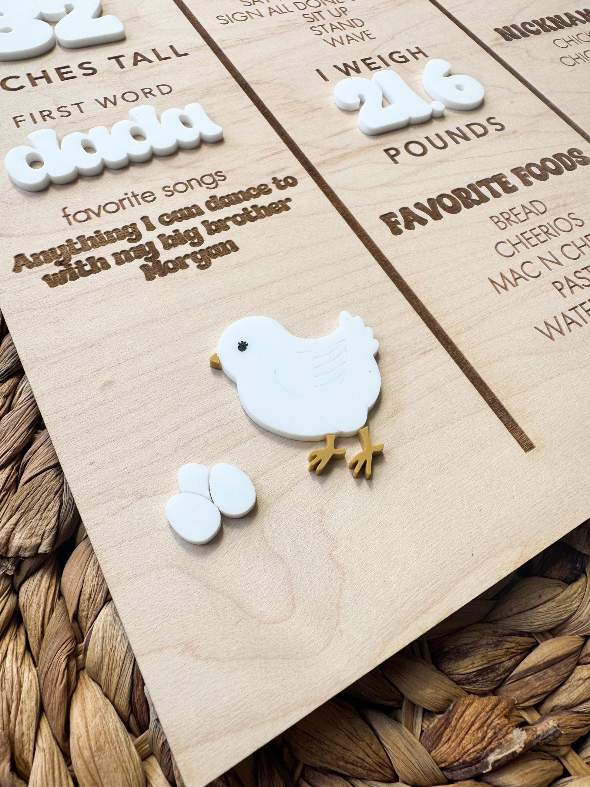 Baby birthday milestone board with decorative chick accent and engraved first year information
