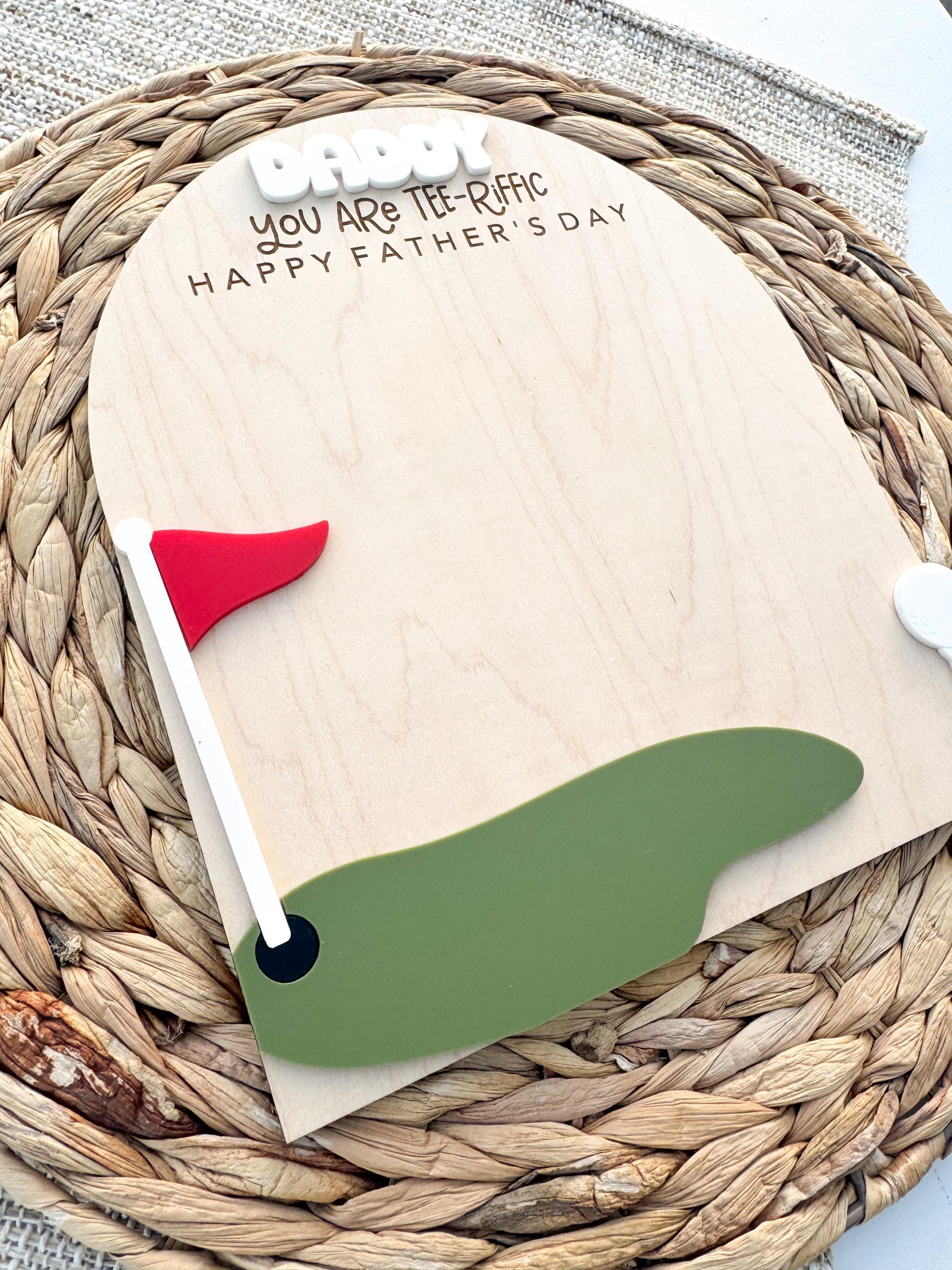Maple wood golf handprint keepsake displayed on woven neutral background