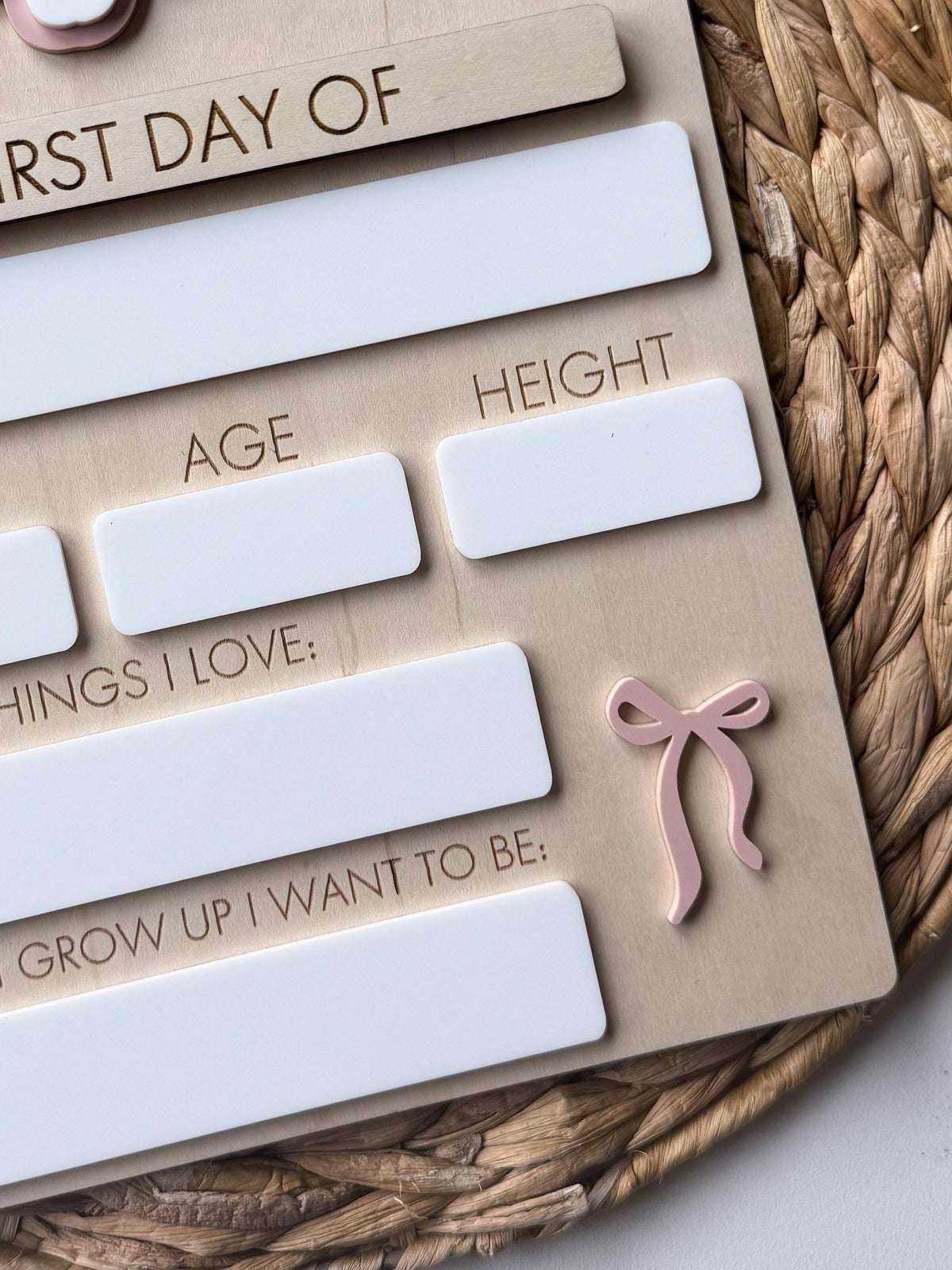Close-up of reusable writing panels and bow accent on a handmade personalized school board.
