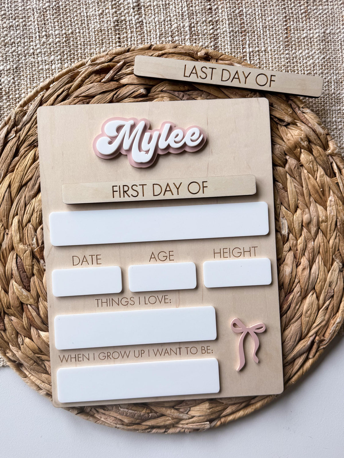 Personalized bow back to school sign with layered acrylic name, interchangeable first day plaque, and reusable dry erase writing sections.