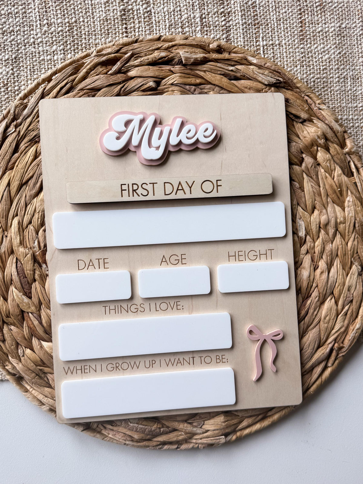 Full view of personalized bow back to school board with layered acrylic name and reusable first and last day plaques.