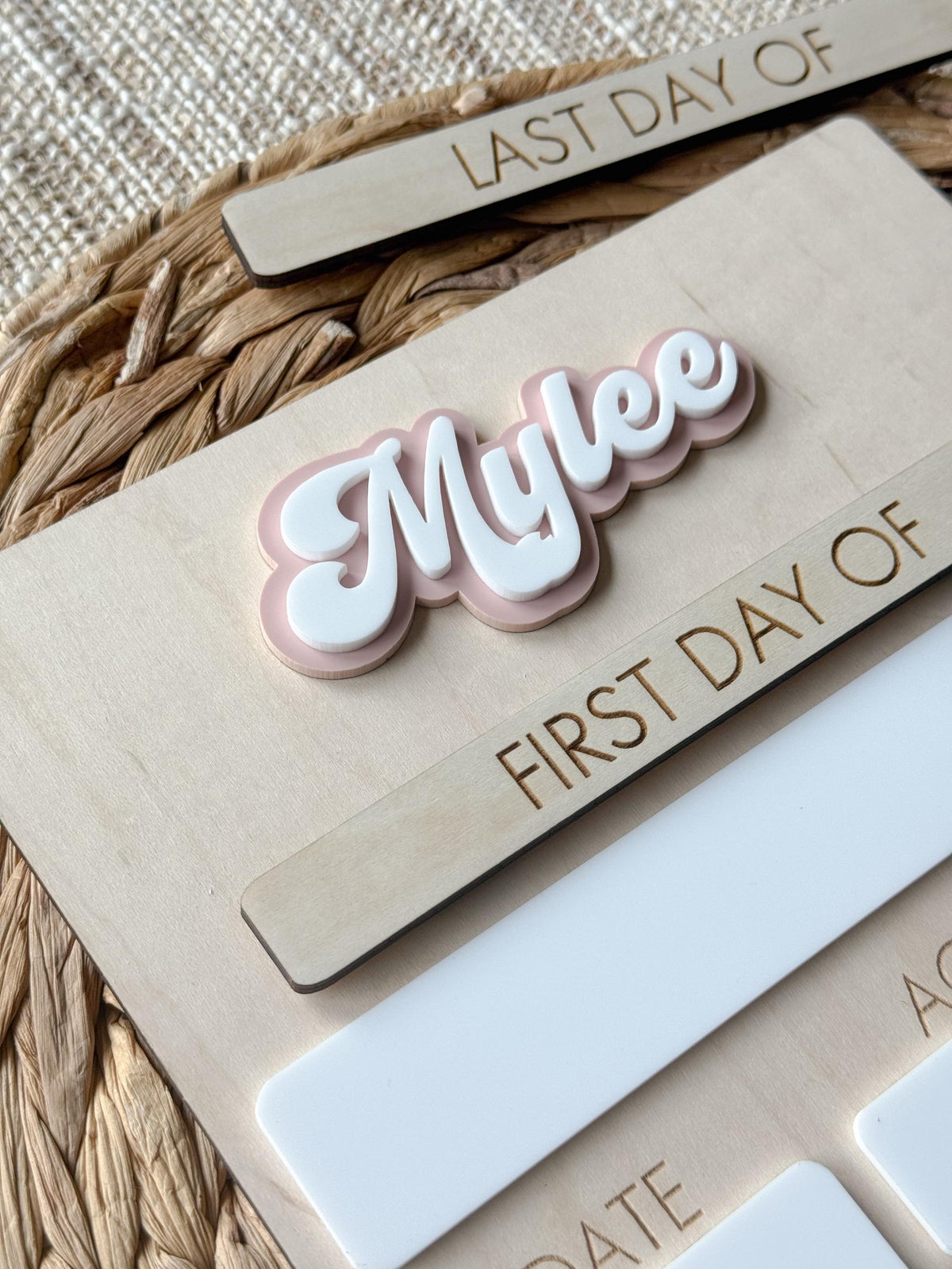 Close-up of layered acrylic personalized name on handmade maple wood school board.