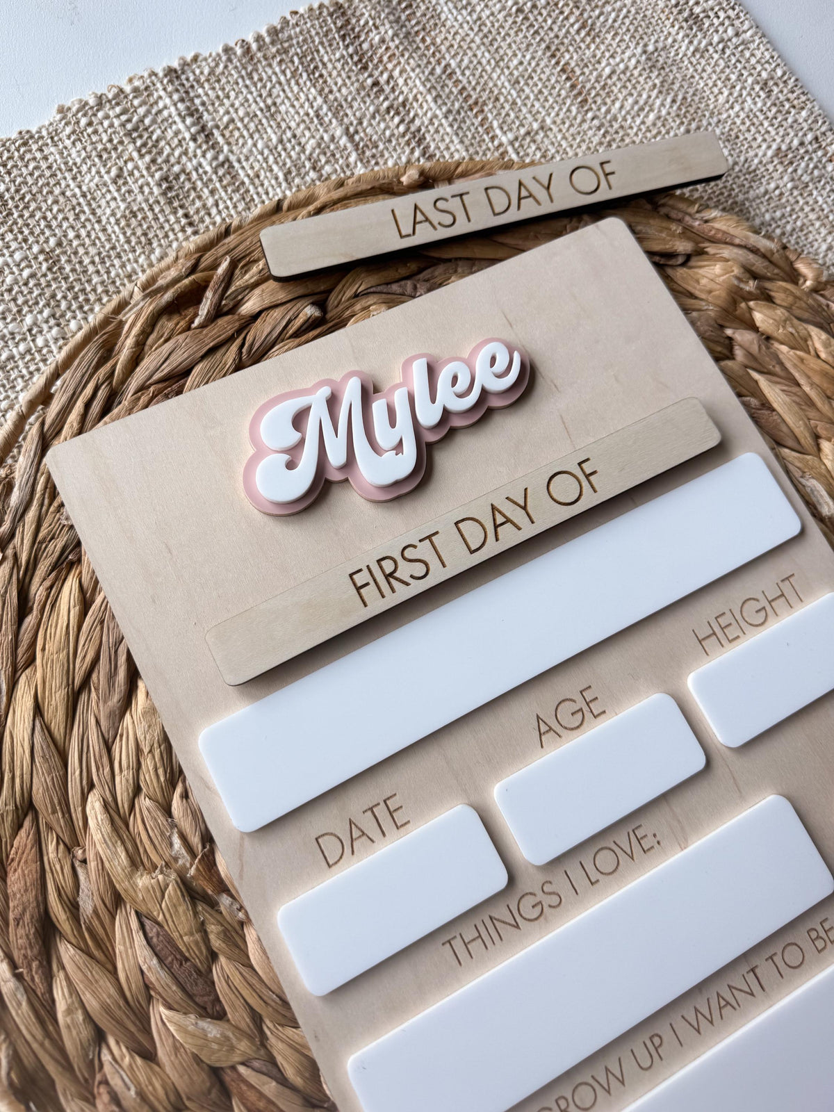 Close-up of layered acrylic personalized name on handmade maple wood school board.