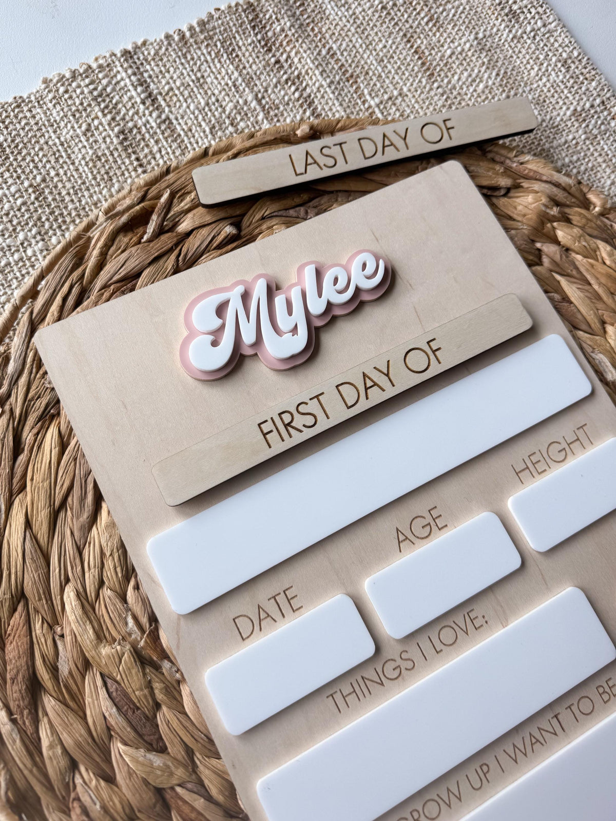 Close-up of layered acrylic personalized name on handmade maple wood school board.
