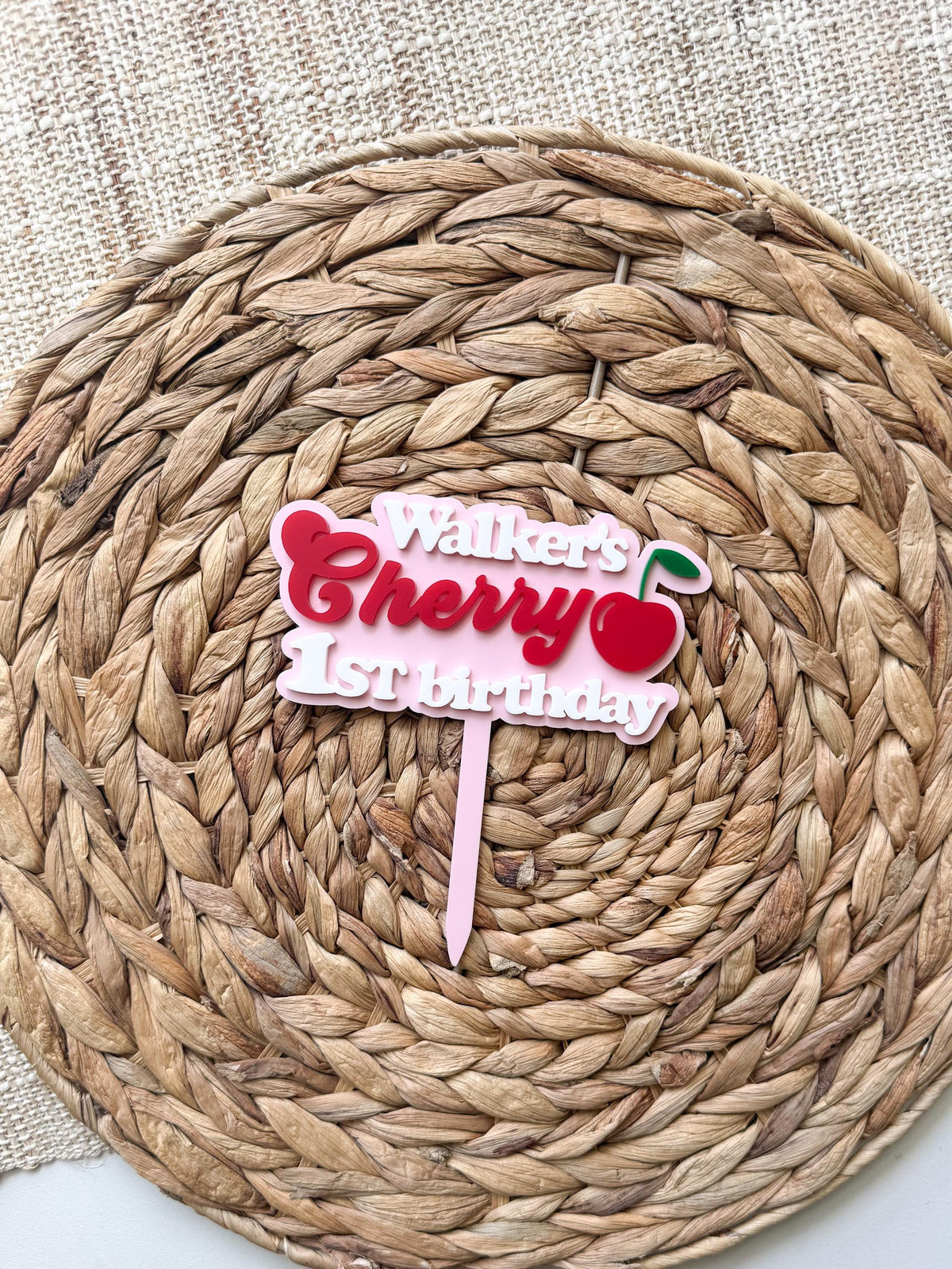 Cherry birthday cake topper personalized with name and age made from layered acrylic party decor