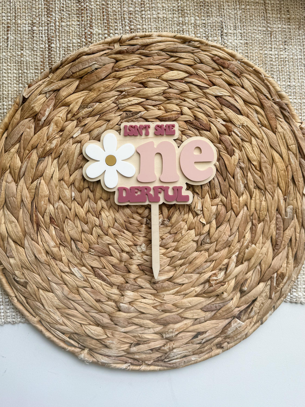 Full view of personalized One-derful cake topper for daisy, floral, or first birthday celebrations.