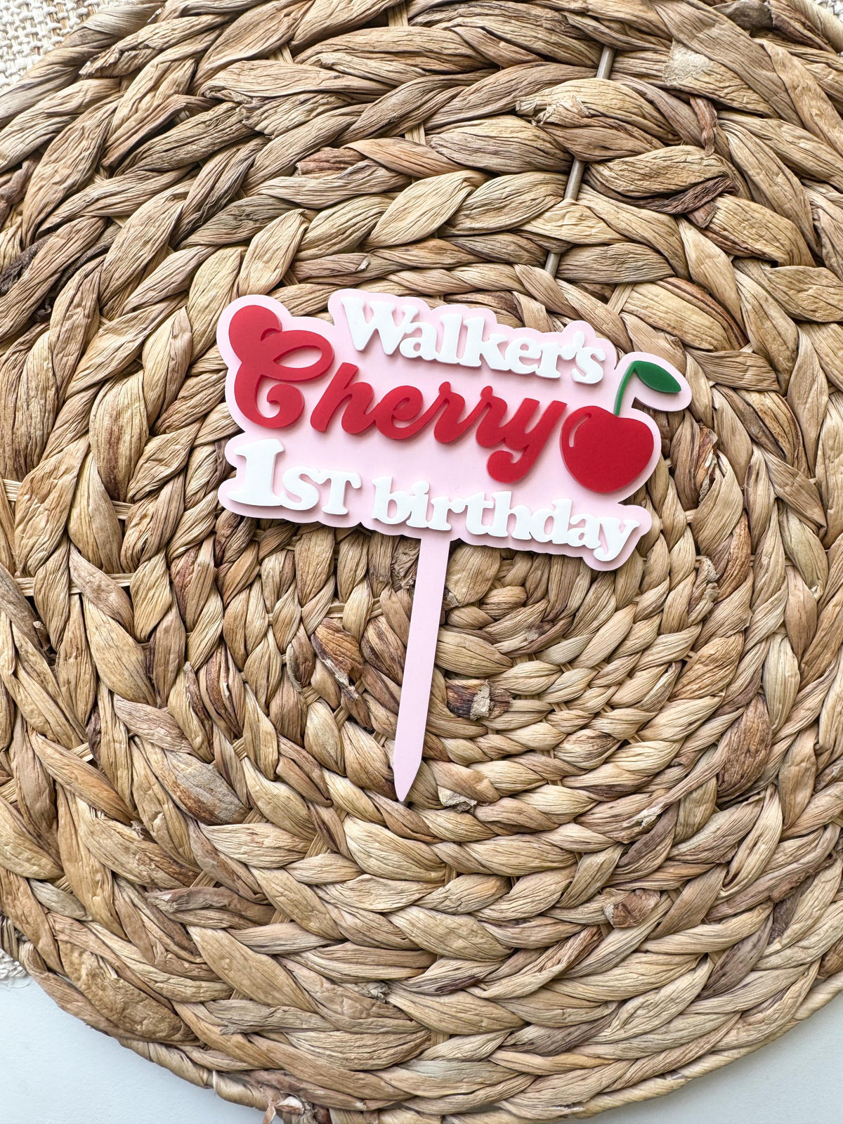 Front view of custom One Sweet Cherry birthday topper with personalized name and cherry accent.