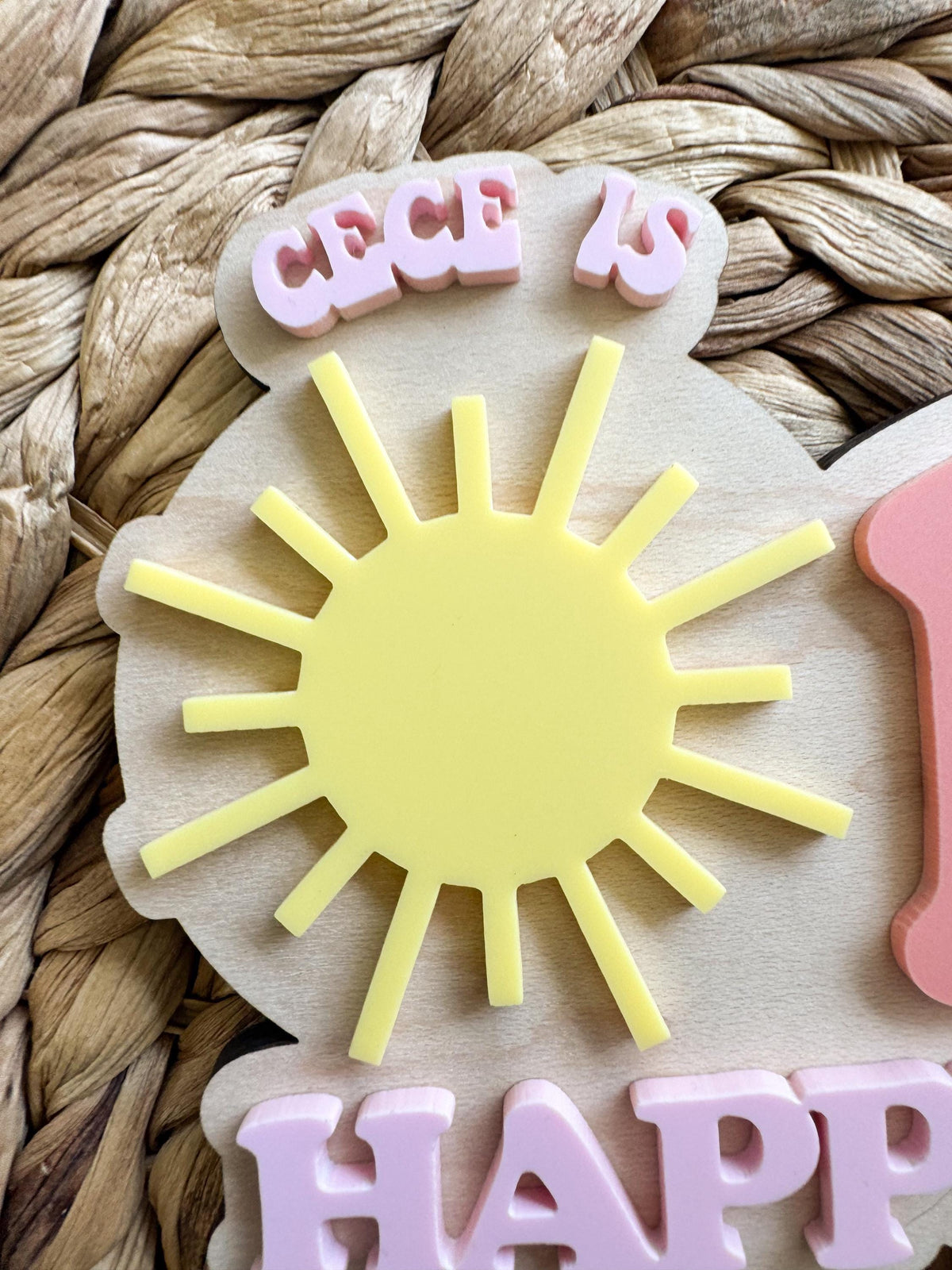Close-up of layered sunshine accent on personalized One Happy Girl birthday cake topper.