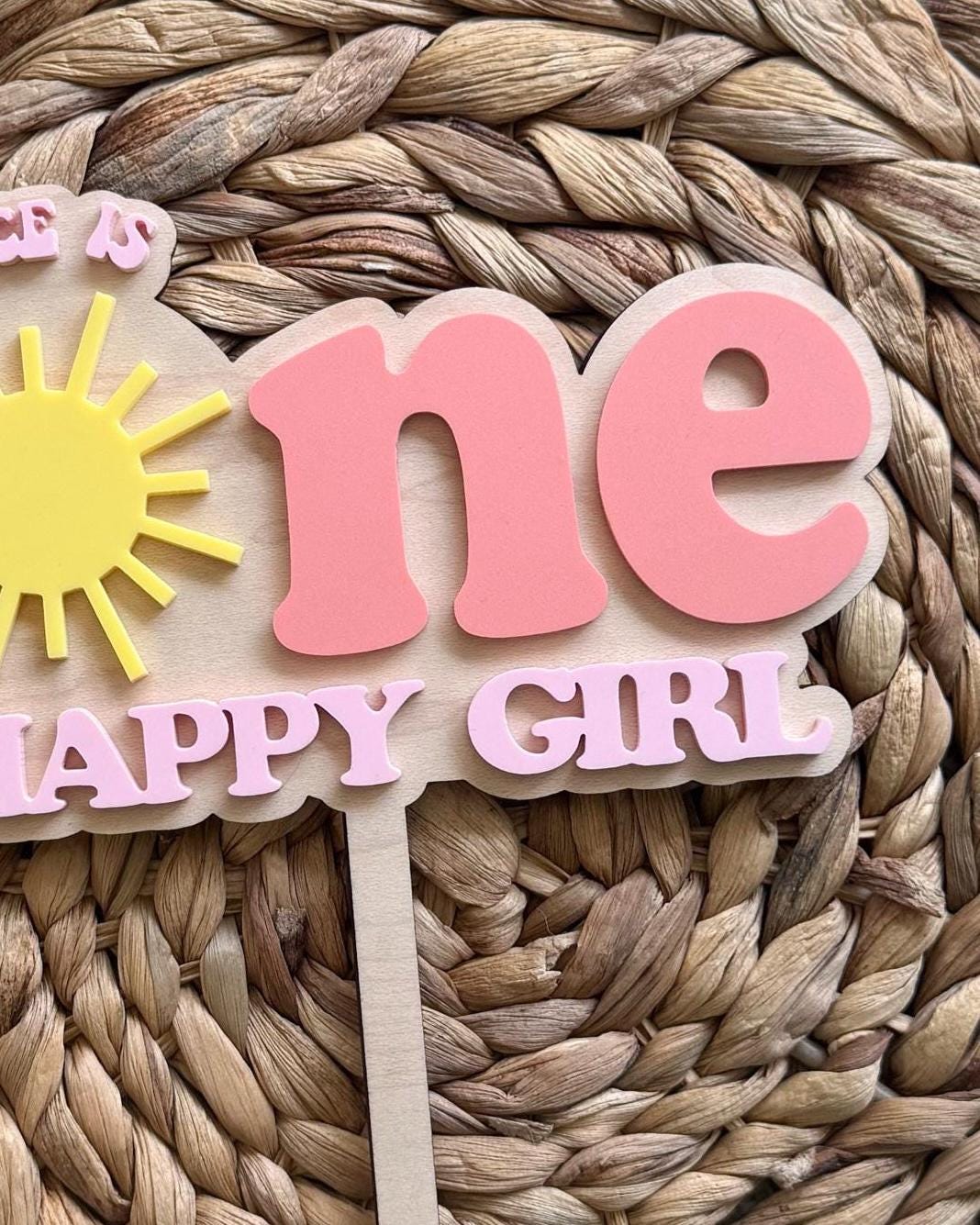 Close-up of layered pink acrylic lettering on handmade One Happy Girl birthday cake topper.