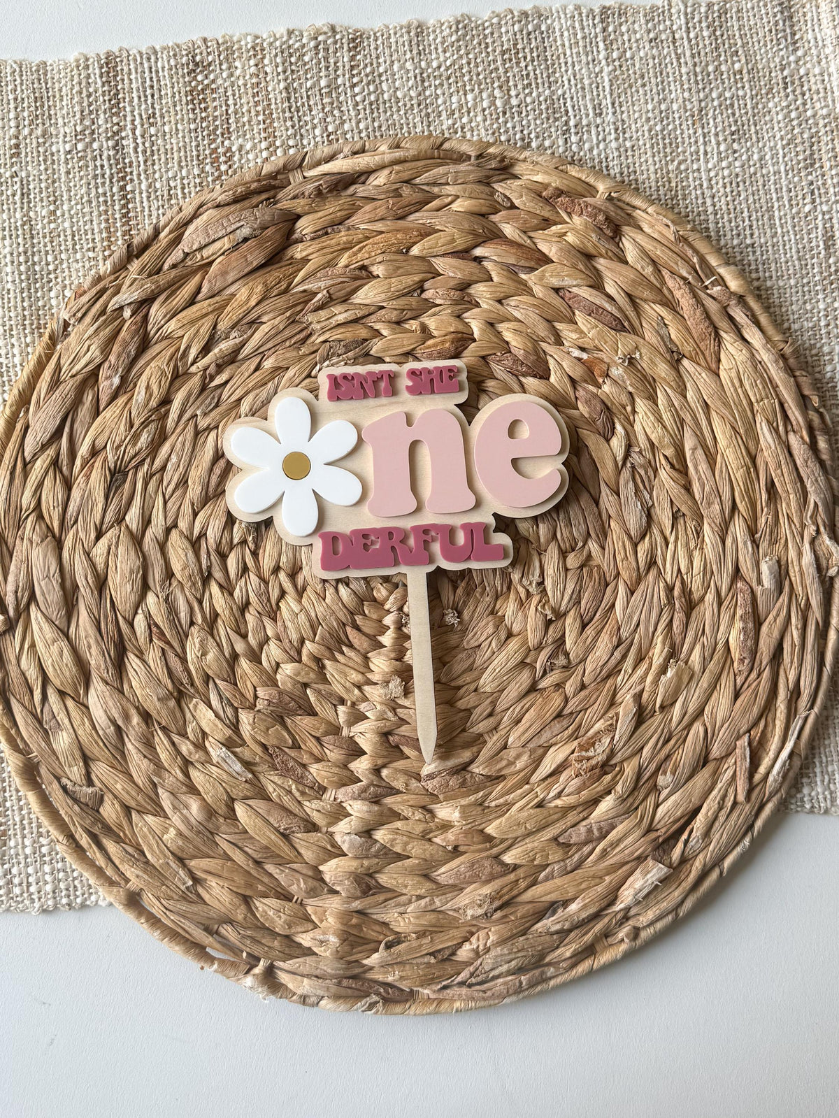 Personalized One-derful first birthday cake topper with layered daisy flower and pink acrylic lettering.