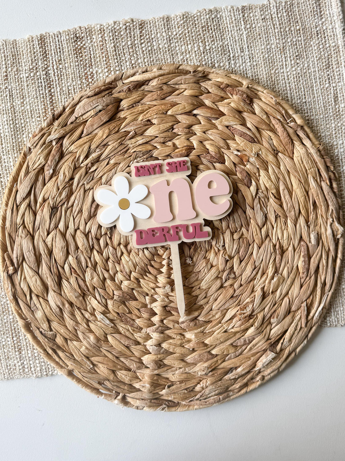 Centered view of personalized One-derful cake topper with custom name and daisy accent.